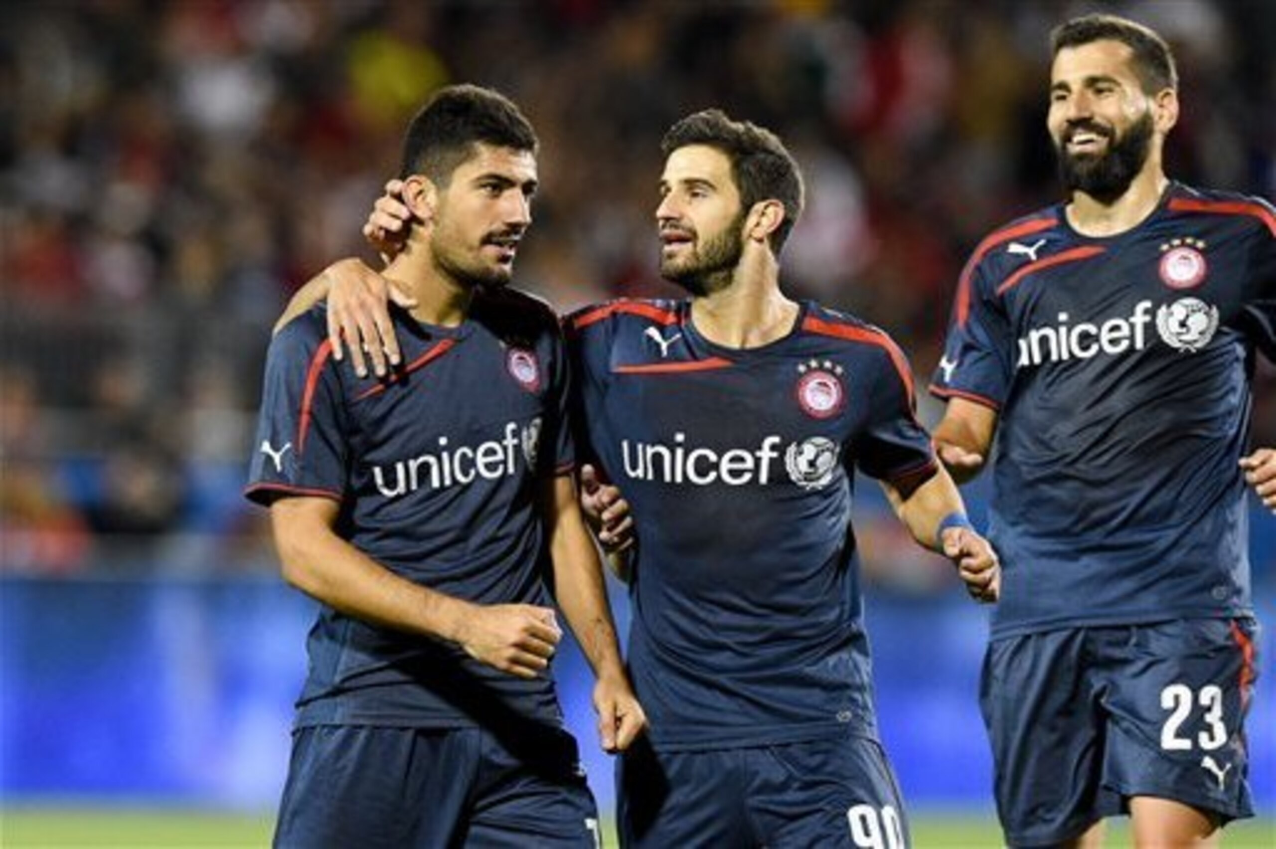 Olympiacos celebrate a goal against Milan.
