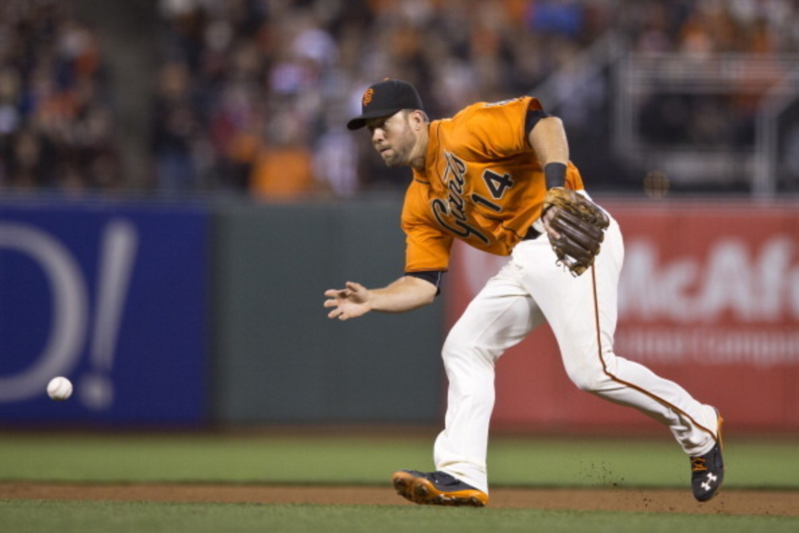 SAN FRANCISCO, CA - MAY 23: Brandon Hicks #14 of the San Francisco Giants fields a ground ball hit off the bat of Joe Mauer #7 of the Minnesota Twins (not pictured) during the seventh inning at AT&T Park on May 23, 2014 in San Francisco, California. The S