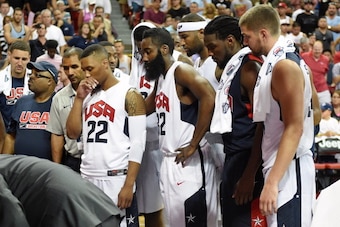 LAS VEGAS, NV - AUGUST 01:  (L-R) Damian Lillard #22, James Harden #32, DeMarcus Cousins #36, Kenneth Faried #33 and Chandler Parsons #34 of the 2014 USA Basketball Men's National Team watch medical staff tend to Paul George (not pictured) after he was in