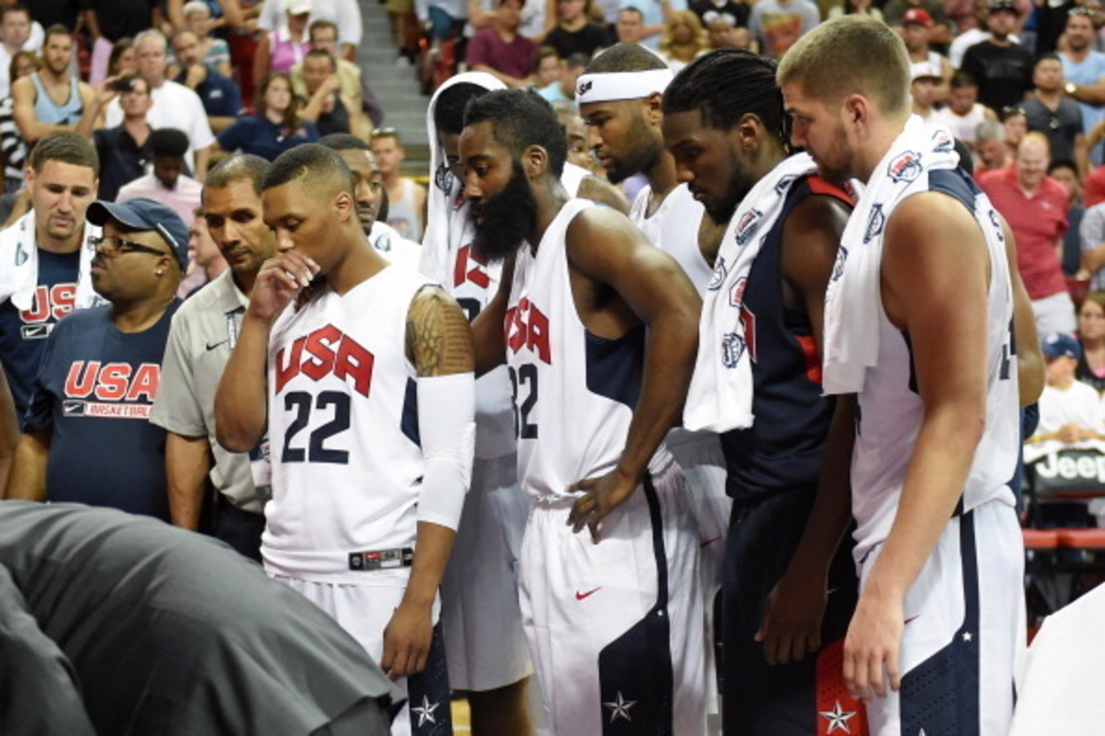 LAS VEGAS, NV - AUGUST 01:  (L-R) Damian Lillard #22, James Harden #32, DeMarcus Cousins #36, Kenneth Faried #33 and Chandler Parsons #34 of the 2014 USA Basketball Men's National Team watch medical staff tend to Paul George (not pictured) after he was in