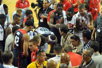 Aug 1, 2014; Las Vegas, NV, USA; USA Basketball players DeMarcus Cousins (36) and Kevin Durant (52) offer words of encouragement to guard Paul George as he is taken off the court on a gurney after suffering a leg injury during the USA Basketball Showcase