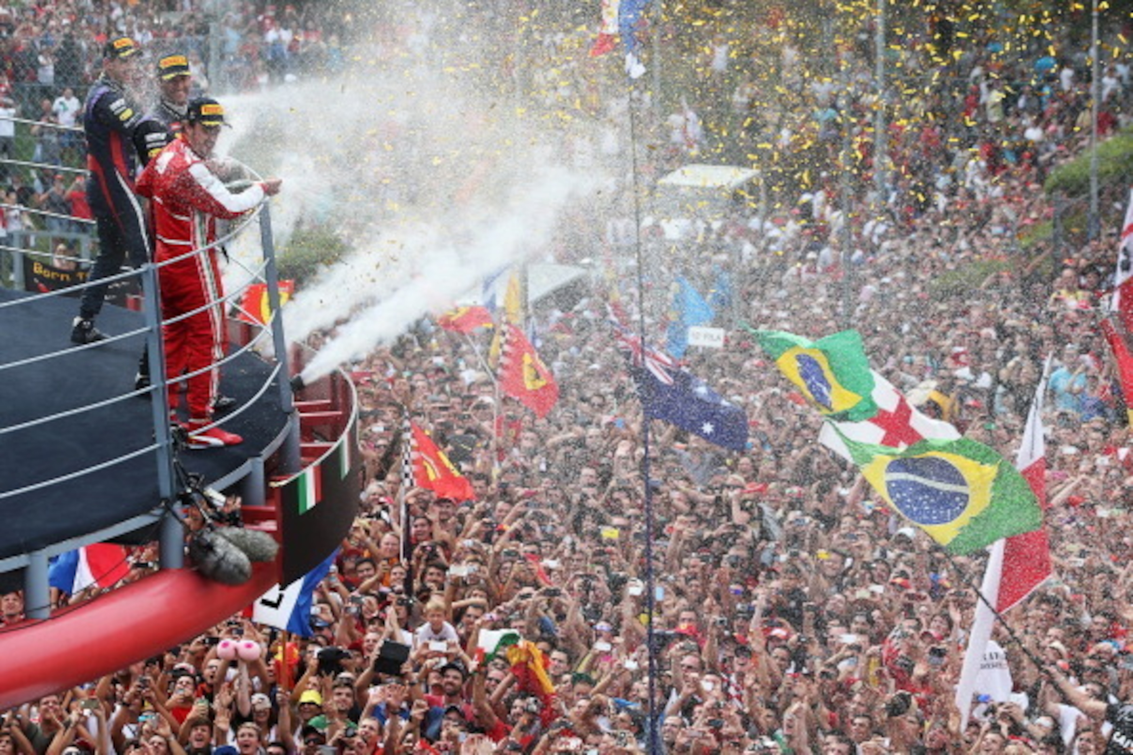 MONZA, ITALY - SEPTEMBER 08:  Race winner Sebastian Vettel (L) of Germany and Infiniti Red Bull Racing, second placed Fernando Alonso (R) of Spain and Ferrari and third placed Mark Webber (C) of Australia and Infiniti Red Bull Racing celebrate on the podi
