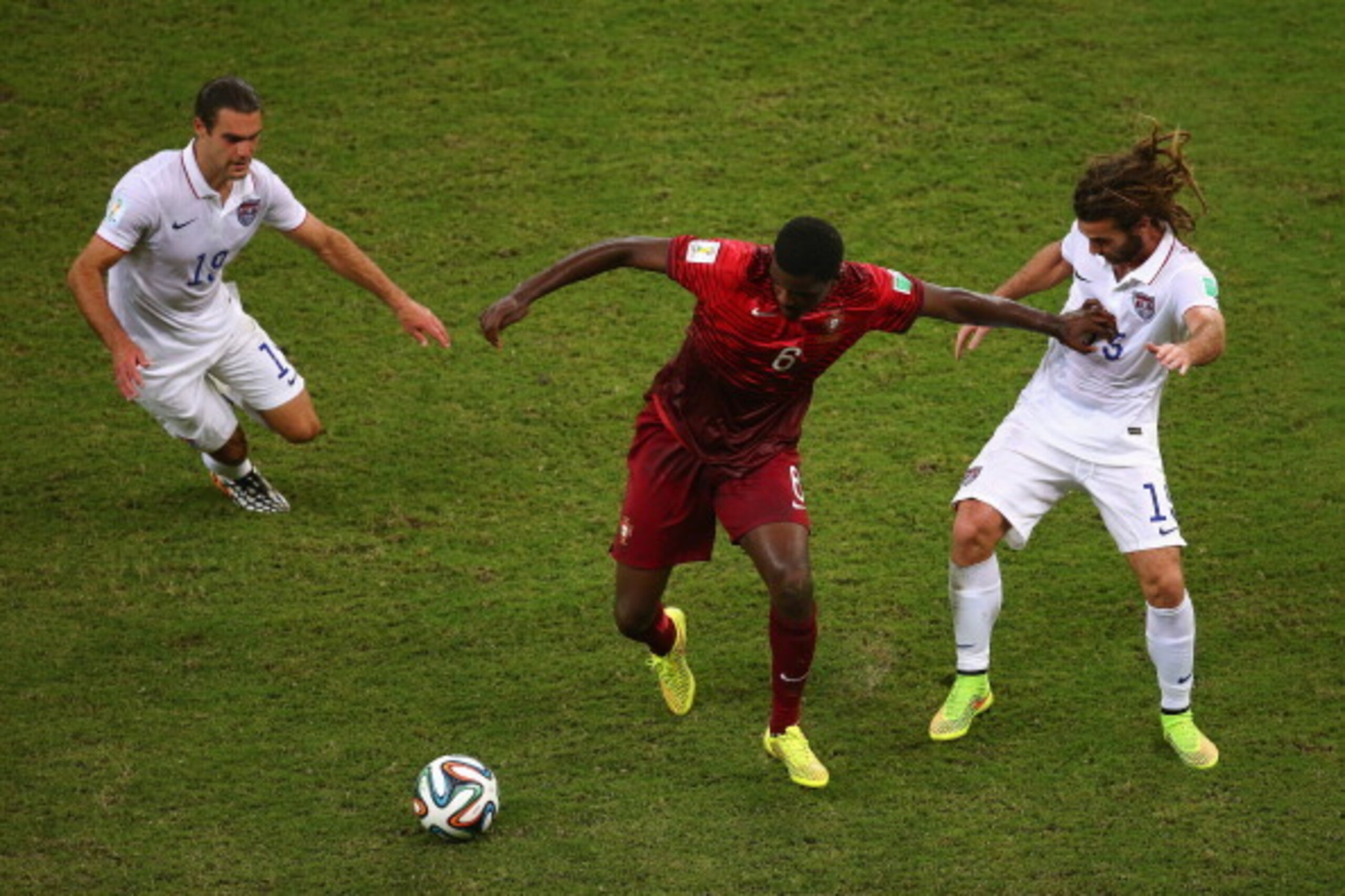 MANAUS, BRAZIL - JUNE 22: William Carvalho of Portugal takes on Graham Zusi and Kyle Beckerman of the United States during the 2014 FIFA World Cup Brazil Group G match between the United States and Portugal at Arena Amazonia on June 22, 2014 in Manaus, B MANAUS, BRAZIL - JUNE 22: William Carvalho of Portugal takes on Graham Zusi and Kyle Beckerman of the United States during the 2014 FIFA World Cup Brazil Group G match between the United States and Portugal at Arena Amazonia on June 22, 2014 in Manaus, B