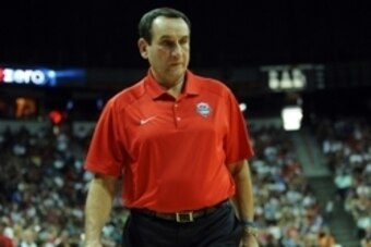 Aug 1, 2014; Las Vegas, NV, USA; USA Basketball head coach Mike Krzyzewski walks over to observe injured Paul George as he is tended to by medical personnel during the USA Basketball Showcase at Thomas & Mack Center. Mandatory Credit: Stephen R. Sylvanie-