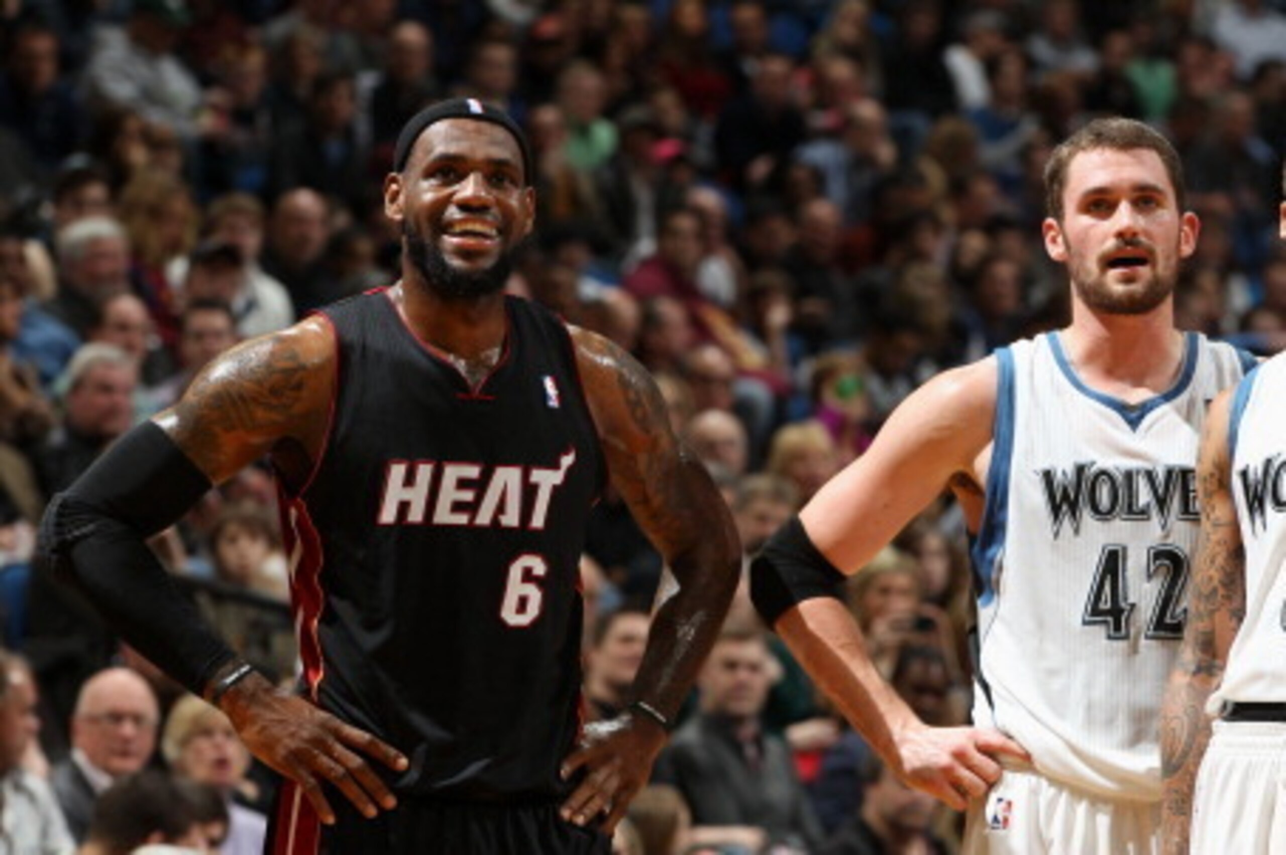 MINNEAPOLIS, MN - DECEMBER 30:  LeBron James #6 of the Miami Heat looks on with Kevin Love #42 and Michael Beasley #8 of the Minnesota Timberwolves during the first quarter on December 30, 2011 at Target Center in Minneapolis, Minnesota.  NOTE TO USER: Us