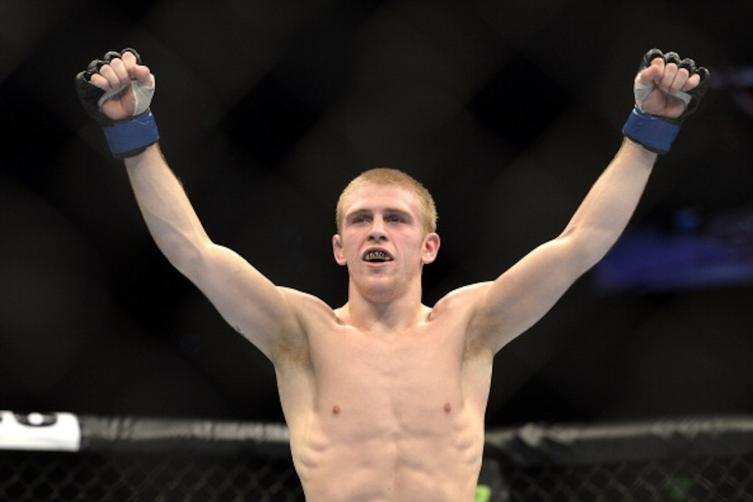 BRISBANE, AUSTRALIA - DECEMBER 07:  Justin Scoggins of the USA celebrates his TKO victory over Richie Vaculik in their flyweight fight during the UFC Fight Night event at the Brisbane Entertainment Centre on December 7, 2013 in Brisbane, Australia.  (Phot