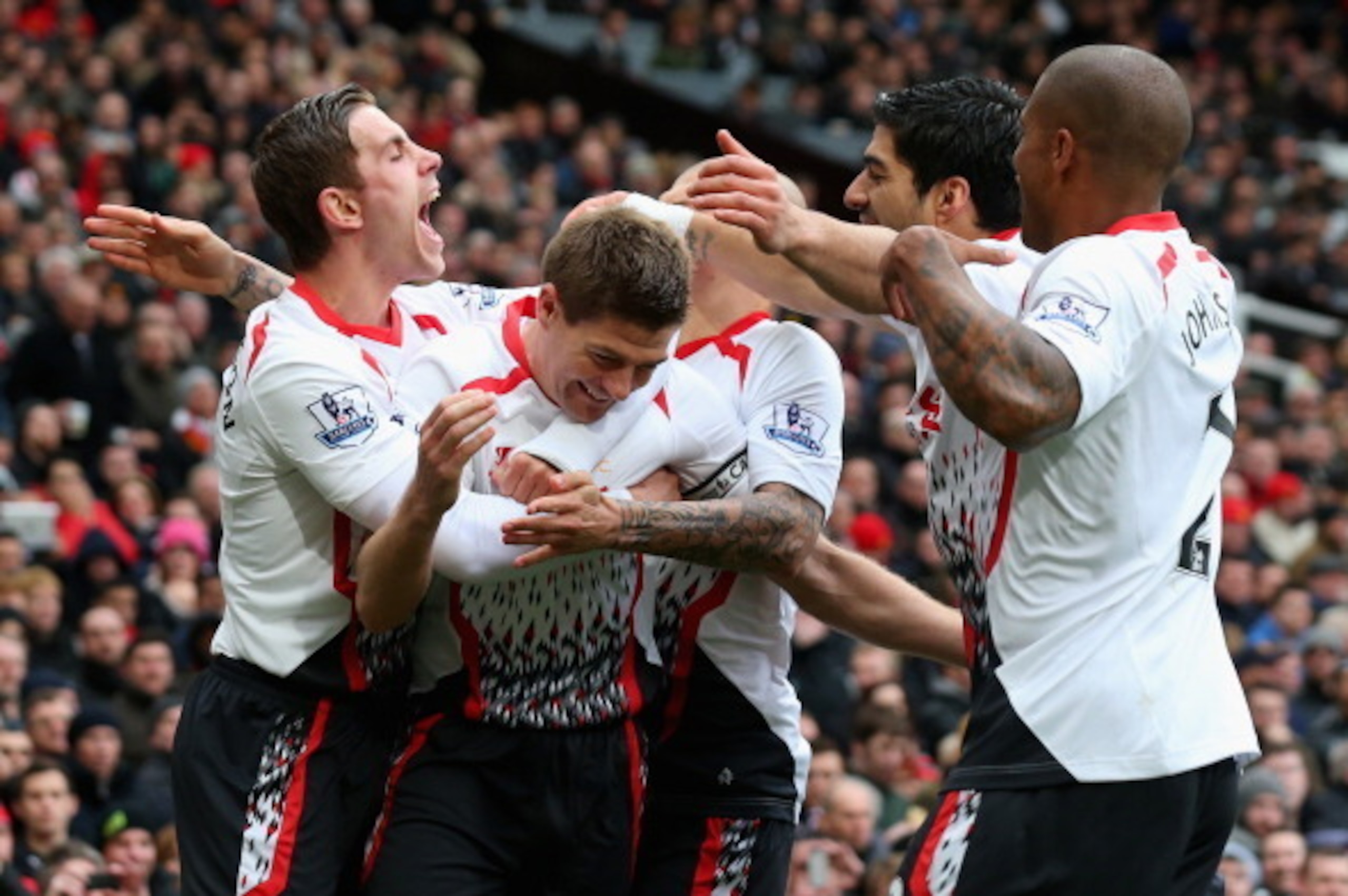 MANCHESTER, ENGLAND - MARCH 16:  Steven Gerrard of Liverpool celebrates scoring the second goal with his team-mates during the Barclays Premier League match between Manchester United and Liverpool at Old Trafford on March 16, 2014 in Manchester, England. 