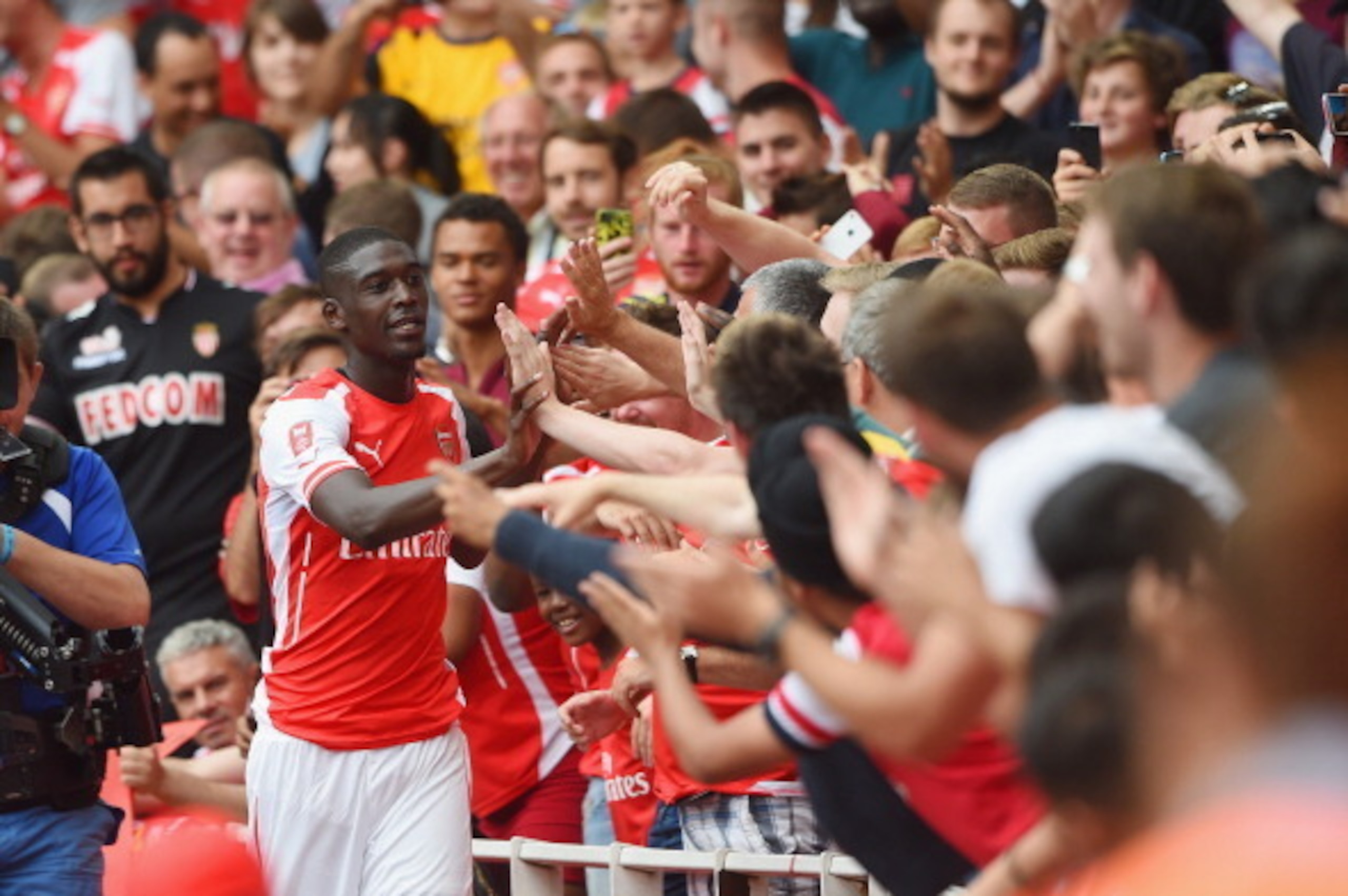 LONDON, ENGLAND - AUGUST 02: Yaya Sanogo of Arsenal celebrates scoring his 4th goal with fans during the Emirates Cup match between Arsenal and Benfica at the Emirates Stadium on August 2, 2014 in London, England. (Photo by Michael Regan/Getty Images) LONDON, ENGLAND - AUGUST 02: Yaya Sanogo of Arsenal celebrates scoring his 4th goal with fans during the Emirates Cup match between Arsenal and Benfica at the Emirates Stadium on August 2, 2014 in London, England. (Photo by Michael Regan/Getty Images)
