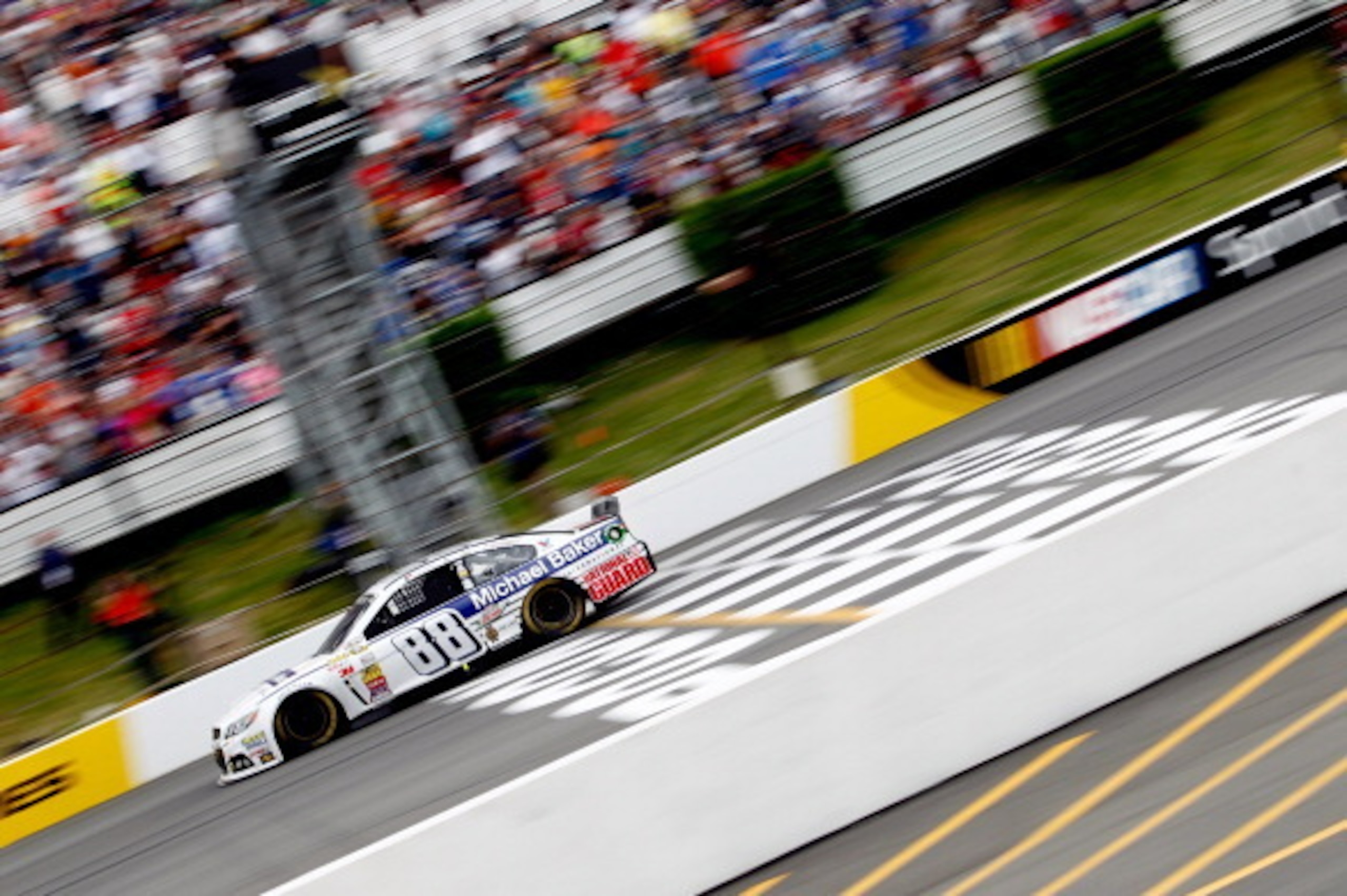 LONG POND, PA - AUGUST 03:  Dale Earnhardt Jr., driver of the #88 Michael Baker International Chevrolet, crosses the finish line to win the NASCAR Sprint Cup Series GoBowling.com 400 at Pocono Raceway on August 3, 2014 in Long Pond, Pennsylvania.  (Photo 
