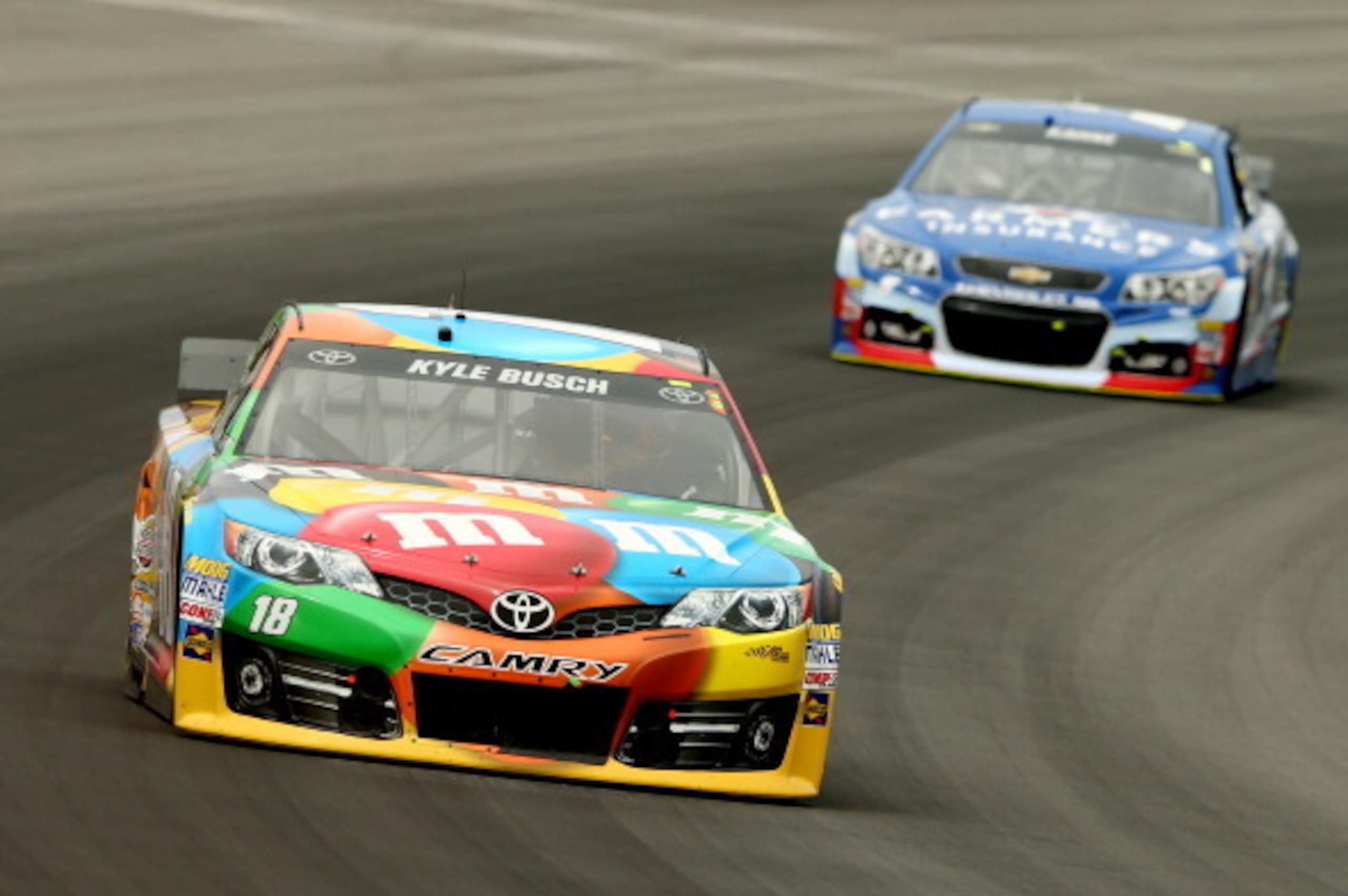 LONG POND, PA - AUGUST 03:  Kyle Busch, driver of the #18 M&M's Toyota, leads Kasey Kahne, driver of the #5 Farmers Insurance Chevrolet, during the NASCAR Sprint Cup Series GoBowling.com 400 at Pocono Raceway on August 3, 2014 in Long Pond, Pennsylvania. 