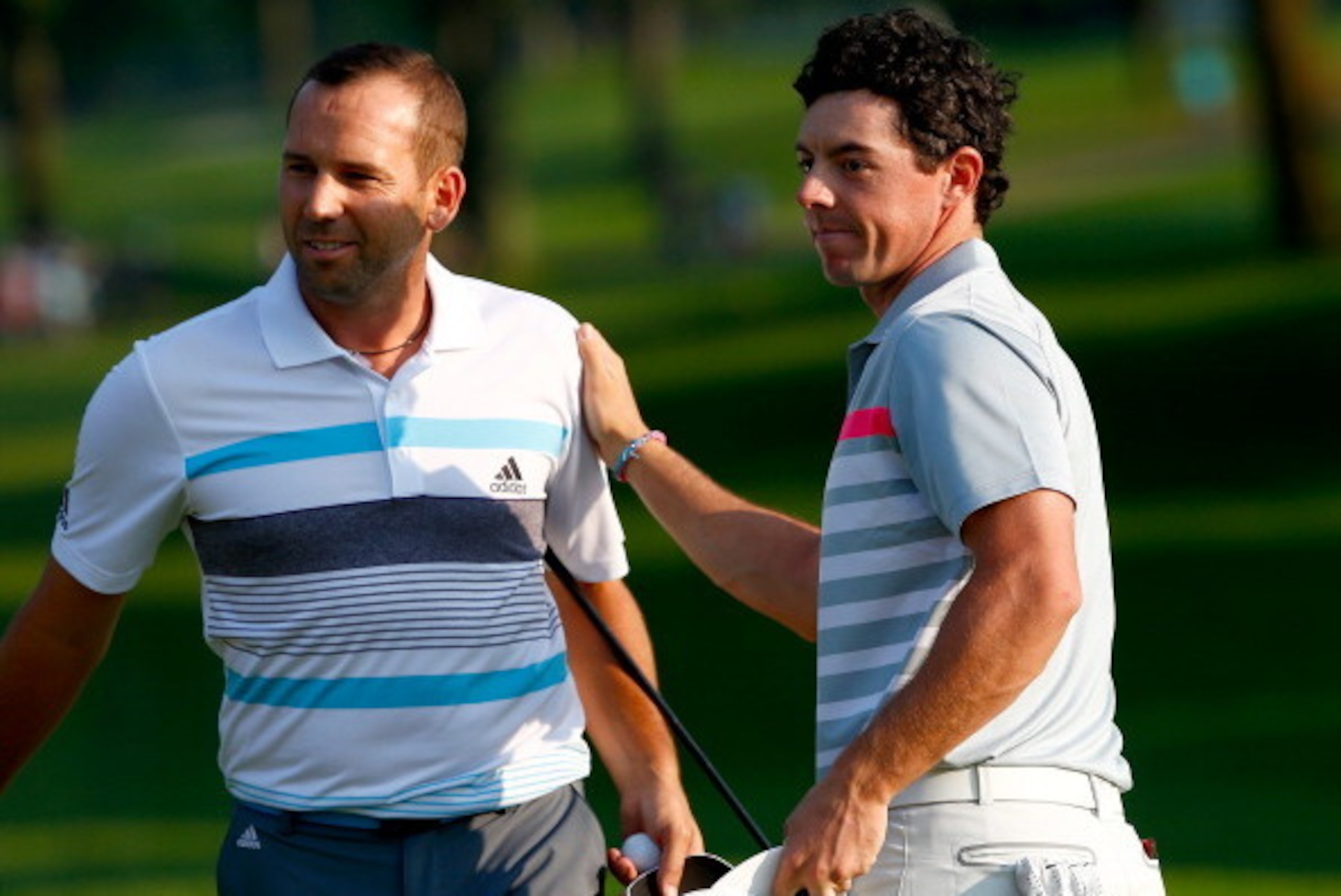 AKRON, OH - AUGUST 03:  Sergio Garcia of Spain congratulates Rory McIlroy of Northern Ireland on his win after putting on the 18th green during the final round of the World Golf Championships-Bridgestone Invitational at Firestone Country Club South Course