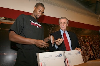 MIAMI - DECEMBER 21: Chris Bosh of the Miami Heat and President of the Miami Heat Pat Riley prepare Care Packages for Soldiers abroad on December 21, 2011 at American Airlines Arena in Miami, Florida. NOTE TO USER: User expressly acknowledges and agrees t