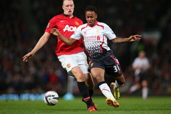 MANCHESTER, ENGLAND - SEPTEMBER 25:  Phil Jones of Manchester United competes with Raheem Sterling of Liverpool during the Capital One Cup Third Round match betwen Manchester United and Liverpool at Old Trafford on September 25, 2013 in Manchester, Englan