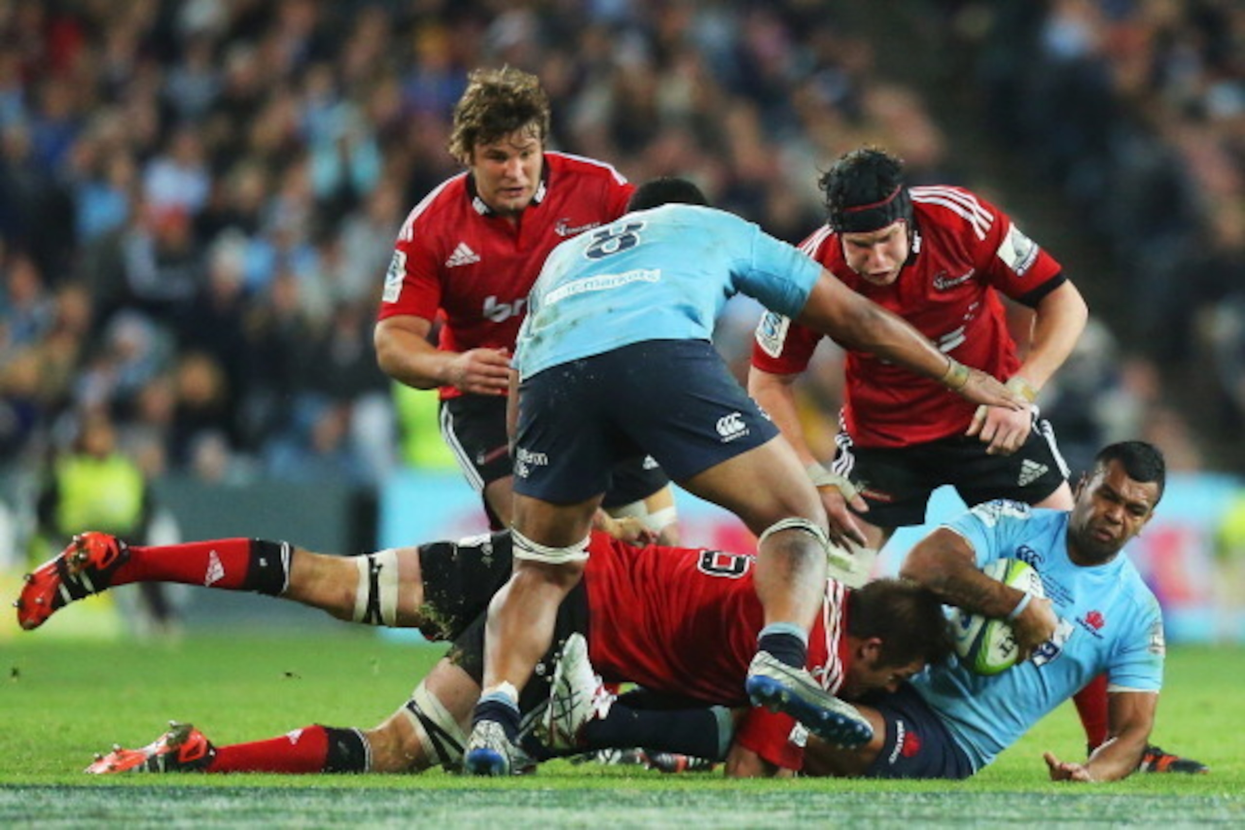 SYDNEY, AUSTRALIA - AUGUST 02:  Kurtley Beale of the Waratahs is tackled by Richie McCaw of the Crusaders during the Super Rugby Grand Final match between the Waratahs and the Crusaders at ANZ Stadium on August 2, 2014 in Sydney, Australia.  (Photo by Joo