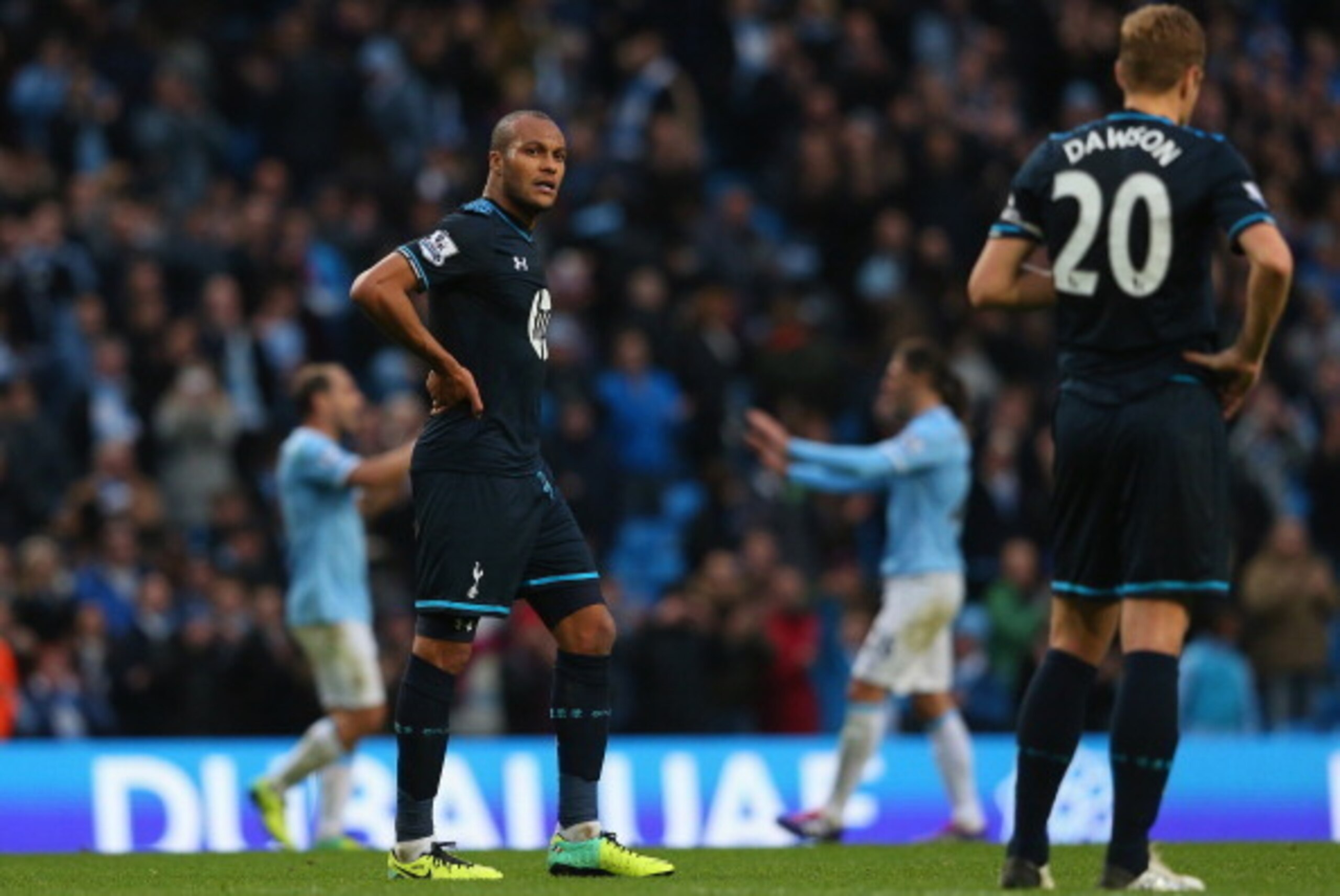 MANCHESTER, ENGLAND - NOVEMBER 24:  Younes Kaboul and Michael Dawson of Tottenham Hotspur look on dejected as Manchester City celebrate after the Barclays Premier League match between Manchester City and Tottenham Hotspur at Etihad Stadium on November 24,