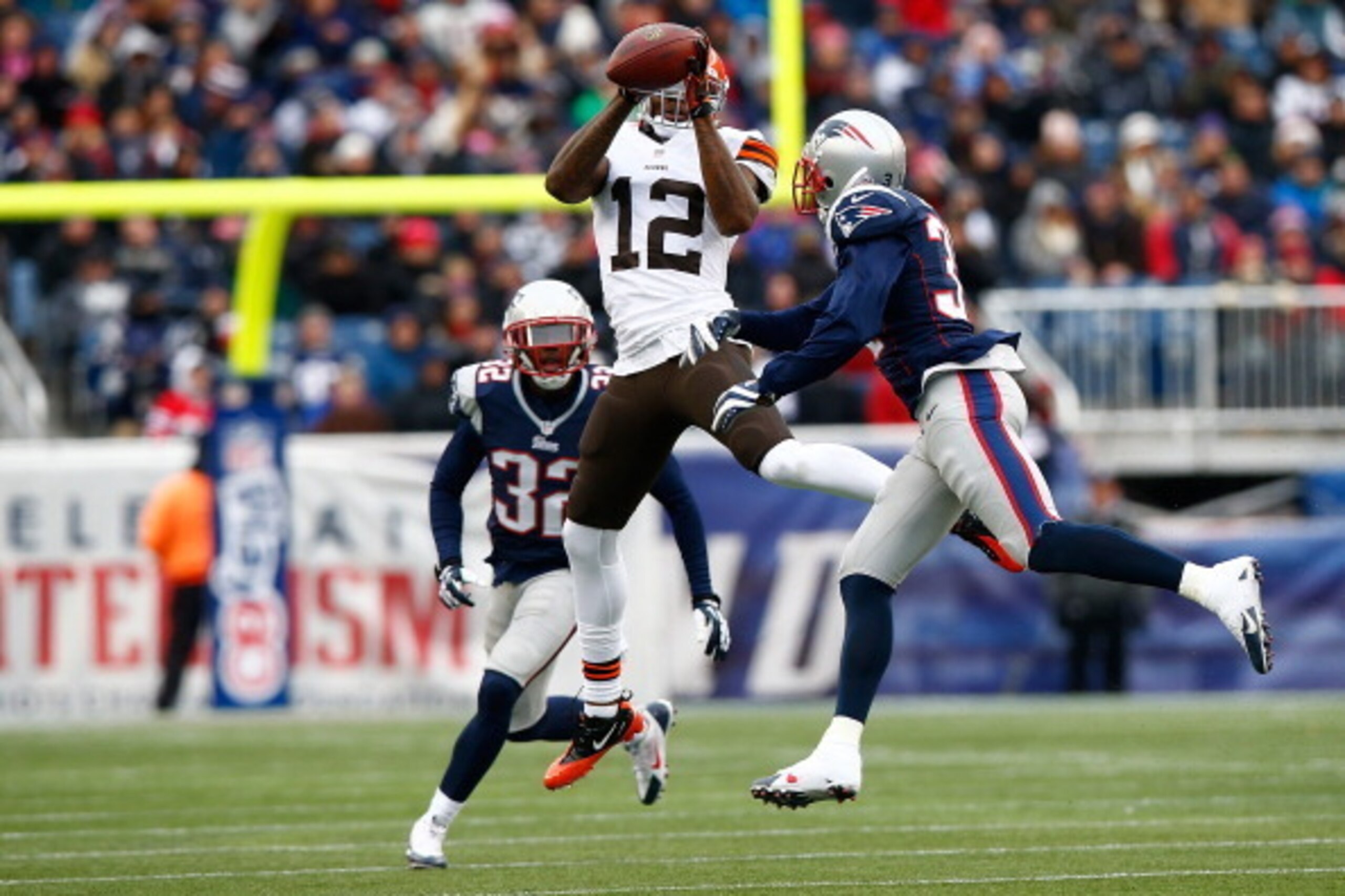 FOXBORO, MA - DECEMBER 08: Josh Gordon #12 of the Cleveland Browns catches a pass in front of Aqib Talib #31 of the New England Patriots in the second quarter during the game at Gillette Stadium on December 8, 2013 in Foxboro, Massachusetts.  (Photo by Ja