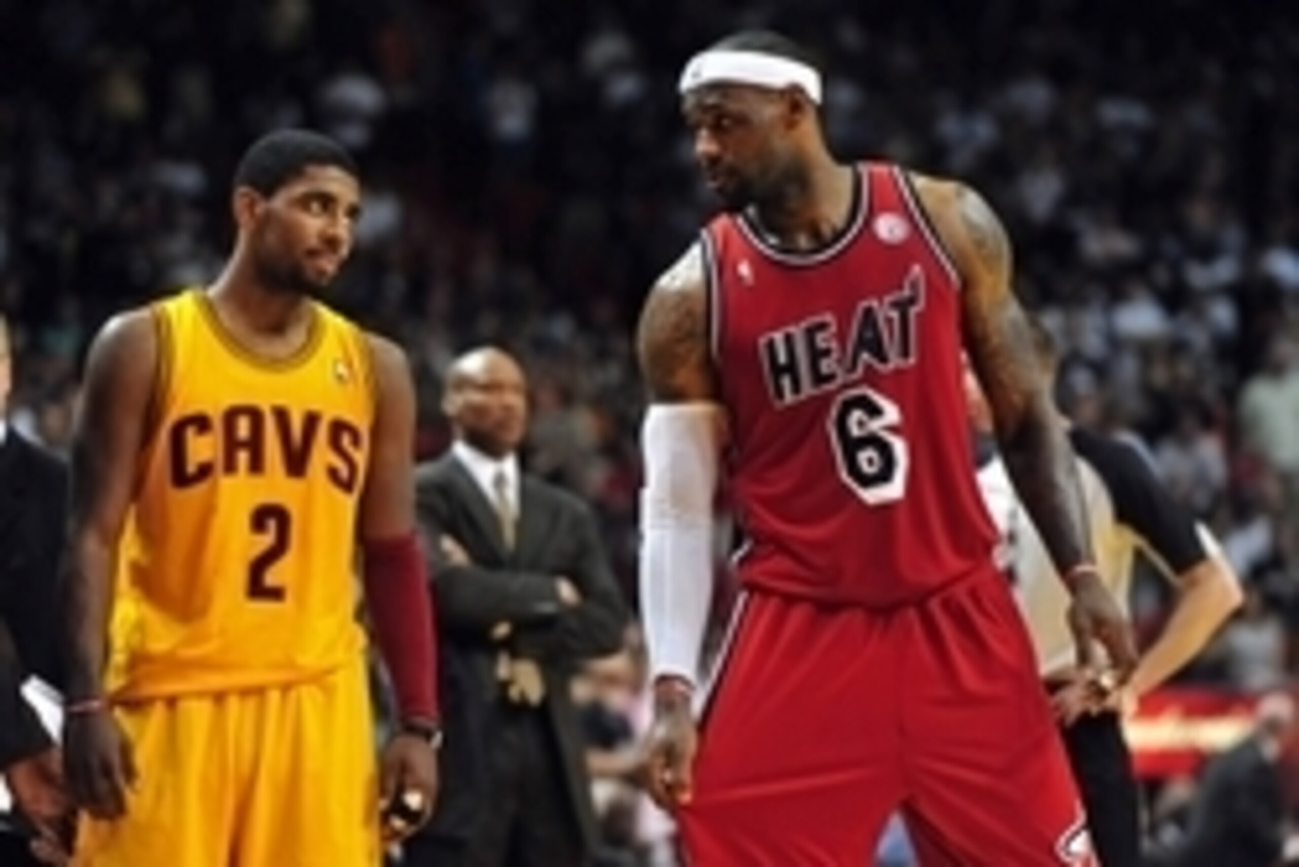 Feb 24, 2013; Miami, FL, USA; Cleveland Cavaliers point guard Kyrie Irving (left) looks over at Miami Heat small forward LeBron James (right) as Cleveland Cavaliers head coach Byron Scott (center) looks on during the second half at the American Airlines A Feb 24, 2013; Miami, FL, USA; Cleveland Cavaliers point guard Kyrie Irving (left) looks over at Miami Heat small forward LeBron James (right) as Cleveland Cavaliers head coach Byron Scott (center) looks on during the second half at the American Airlines A