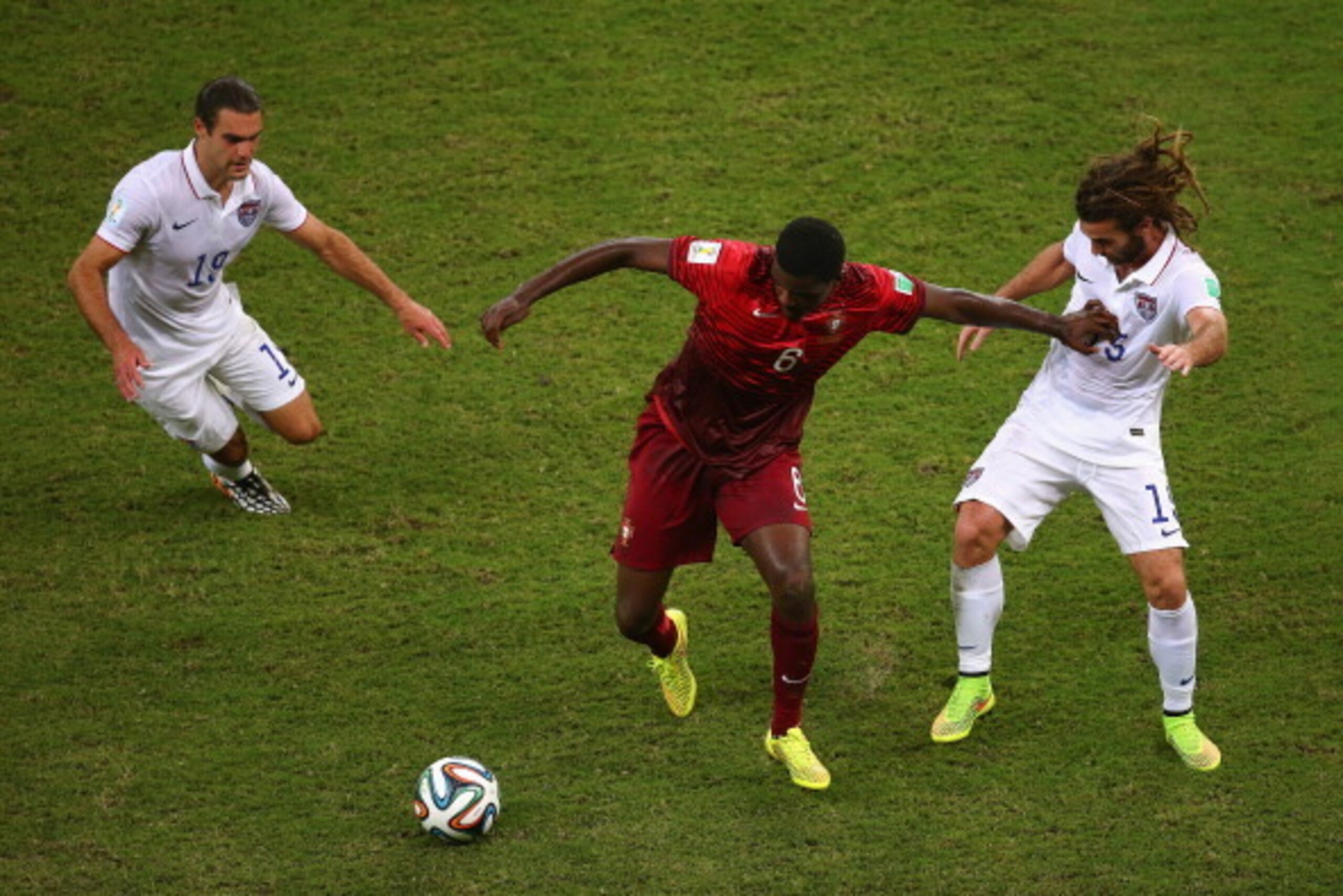 MANAUS, BRAZIL - JUNE 22:  William Carvalho of Portugal takes on Graham Zusi and Kyle Beckerman of the United States during the 2014 FIFA World Cup Brazil Group G match between the United States and Portugal at Arena Amazonia on June 22, 2014 in Manaus, B