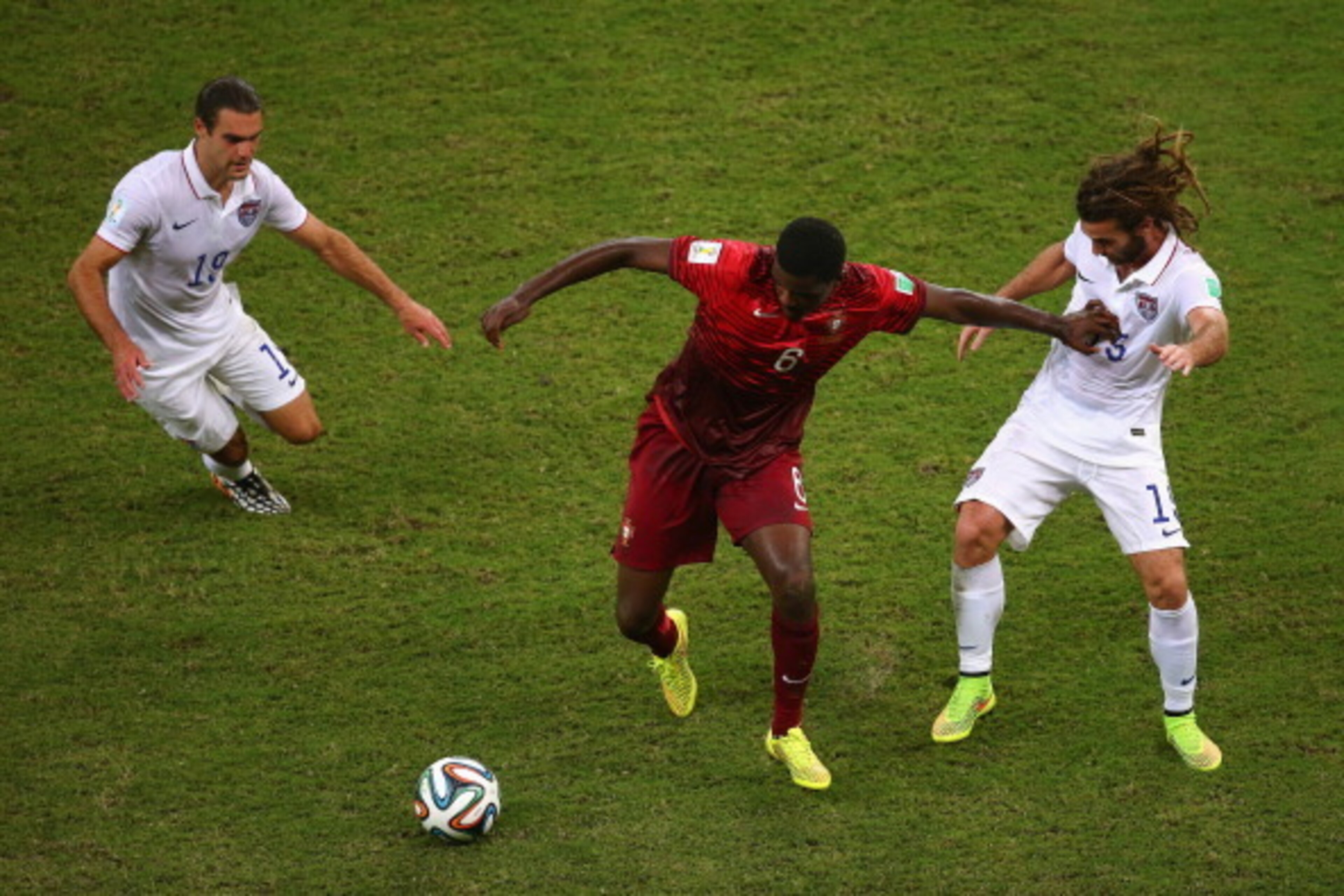 MANAUS, BRAZIL - JUNE 22:  William Carvalho of Portugal takes on Graham Zusi and Kyle Beckerman of the United States during the 2014 FIFA World Cup Brazil Group G match between the United States and Portugal at Arena Amazonia on June 22, 2014 in Manaus, B