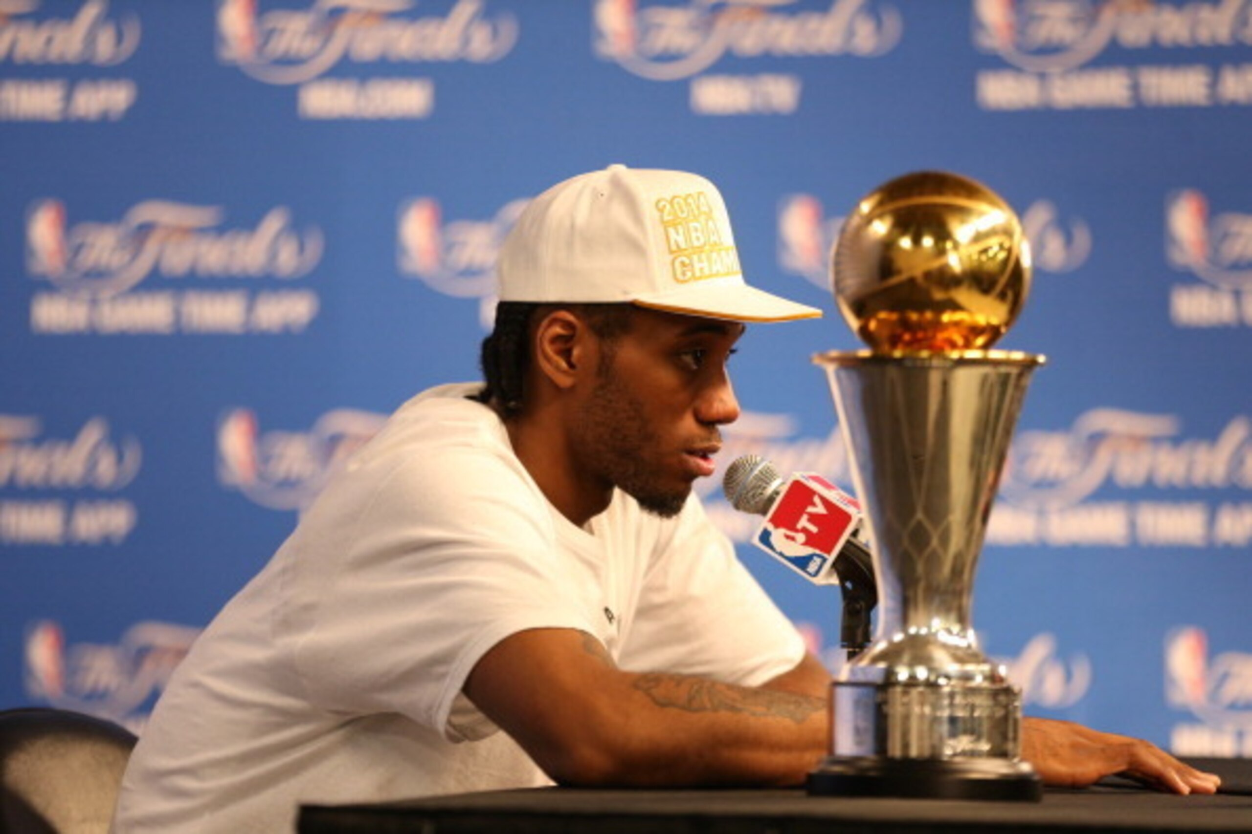 SAN ANTONIO, TX - JUNE 15: Kawhi Leonard #2 of the San Antonio Spurs winner of the Bill Russell NBA Finals Most Valuable Player Award addresses the media after winning the Larry O'Brien Trophy in Game Five of the 2014 NBA Finals against the Miami Heat at 