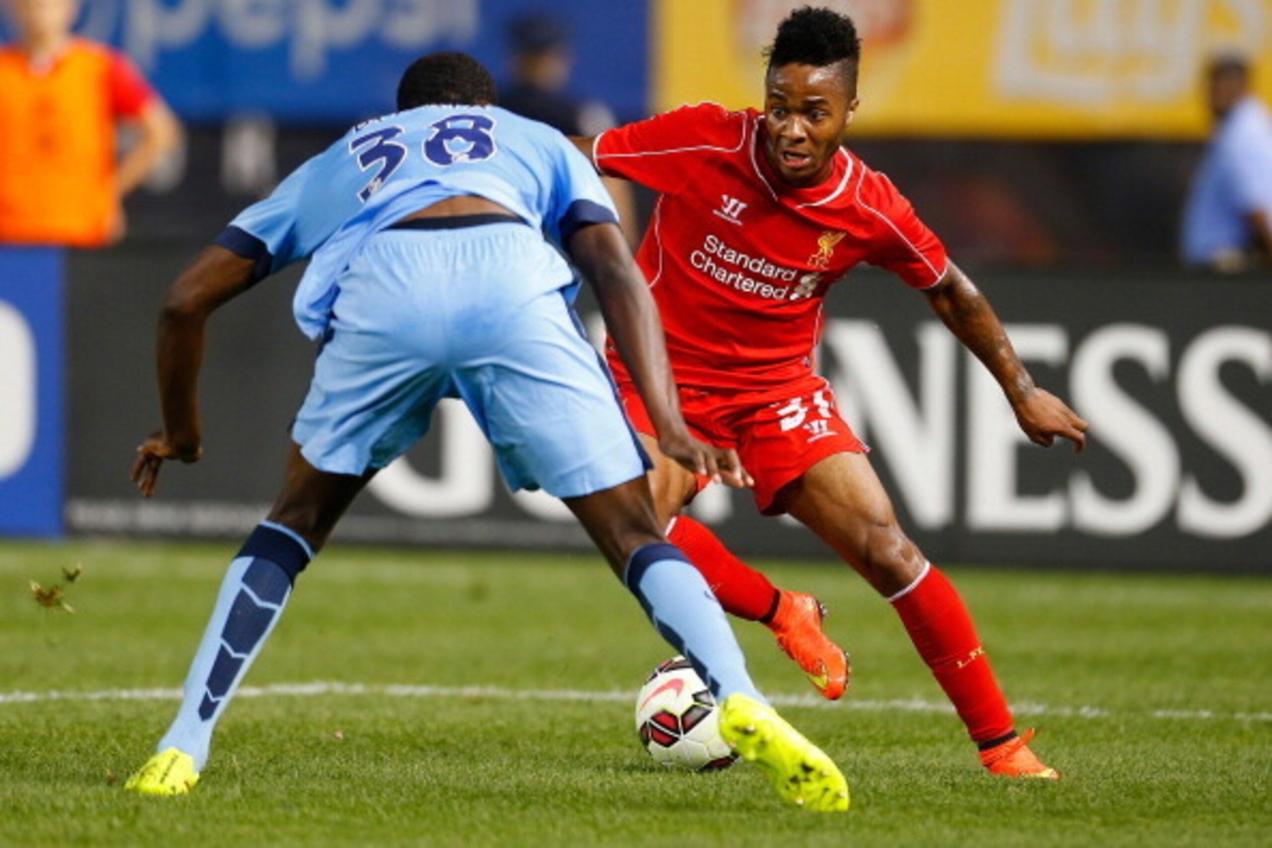 NEW YORK, NY - JULY 30:  Raheem Sterling #31 of Liverpool plays the ball against Dedryck Boyata #38 of Manchester City during the International Champions Cup 2014 at Yankee Stadium on July 30, 2014 in the Bronx borough of New York City.  (Photo by Mike St
