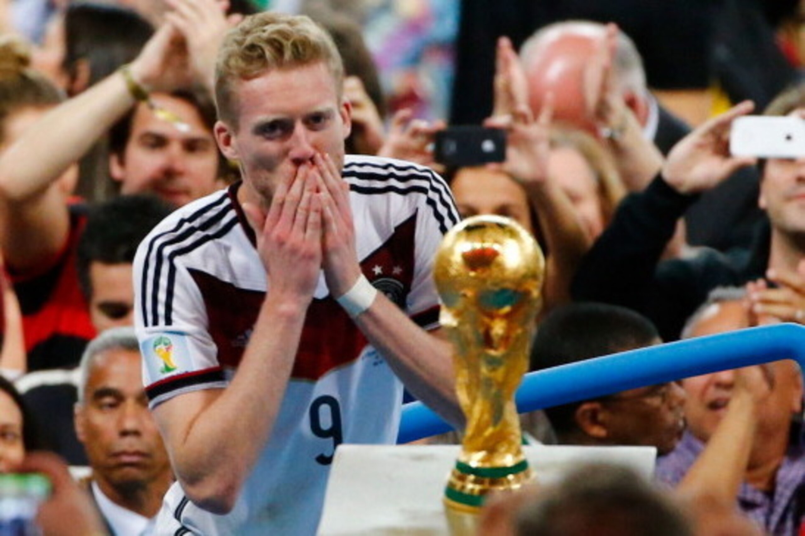 RIO DE JANEIRO, BRAZIL - JULY 13:  Andre Schuerrle of Germany looks at the World Cup trophy after defeating Argentina 1-0 in extra time during the 2014 FIFA World Cup Brazil Final match between Germany and Argentina at Maracana on July 13, 2014 in Rio de 