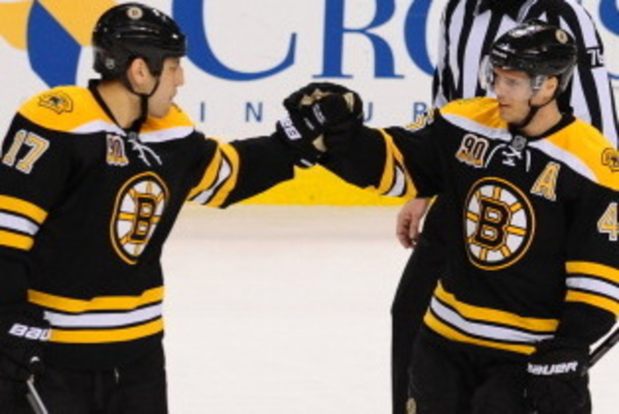 BOSTON, MA - MARCH 4: David Krejci #46 of the Boston Bruins celebrates a hat trick with teammate Milan Lucic #17 against the Florida Panthers at the TD Garden on March 4, 2014 in Boston, Massachusetts.  (Photo by Steve Babineau/NHLI via Getty Images)