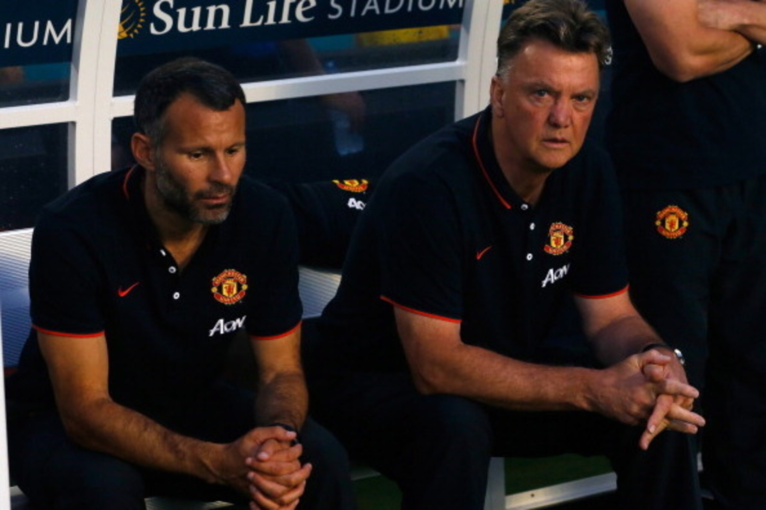 MIAMI GARDENS, FL - AUGUST 04: (L) Ryan Giggs and manager of Manchester United Louis Van Gaal sit on the bench prior to the game against Liverpool in the Guinness International Champions Cup 2014 Final at Sun Life Stadium on August 4, 2014 in Miami Garden