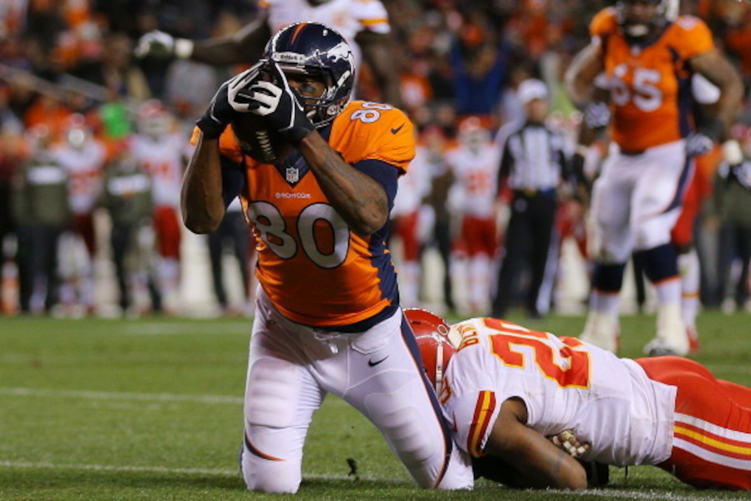 DENVER, CO - NOVEMBER 17:  Julius Thomas #80 of the Denver Broncos scores a first quarter touchdown against the defense of  Eric Berry #29 of the Kansas City Chiefs at Sports Authority Field at Mile High on November 17, 2013 in Denver, Colorado.  (Photo b