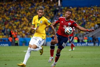 FORTALEZA, BRAZIL - JULY 04: Neymar of Brazil competes for the ball with Juan Camilo Zuniga of Colombia during the 2014 FIFA World Cup Brazil Quarter Final match between Brazil and Colombia at Castelao on July 4, 2014 in Fortaleza, Brazil.  (Photo by Gabr