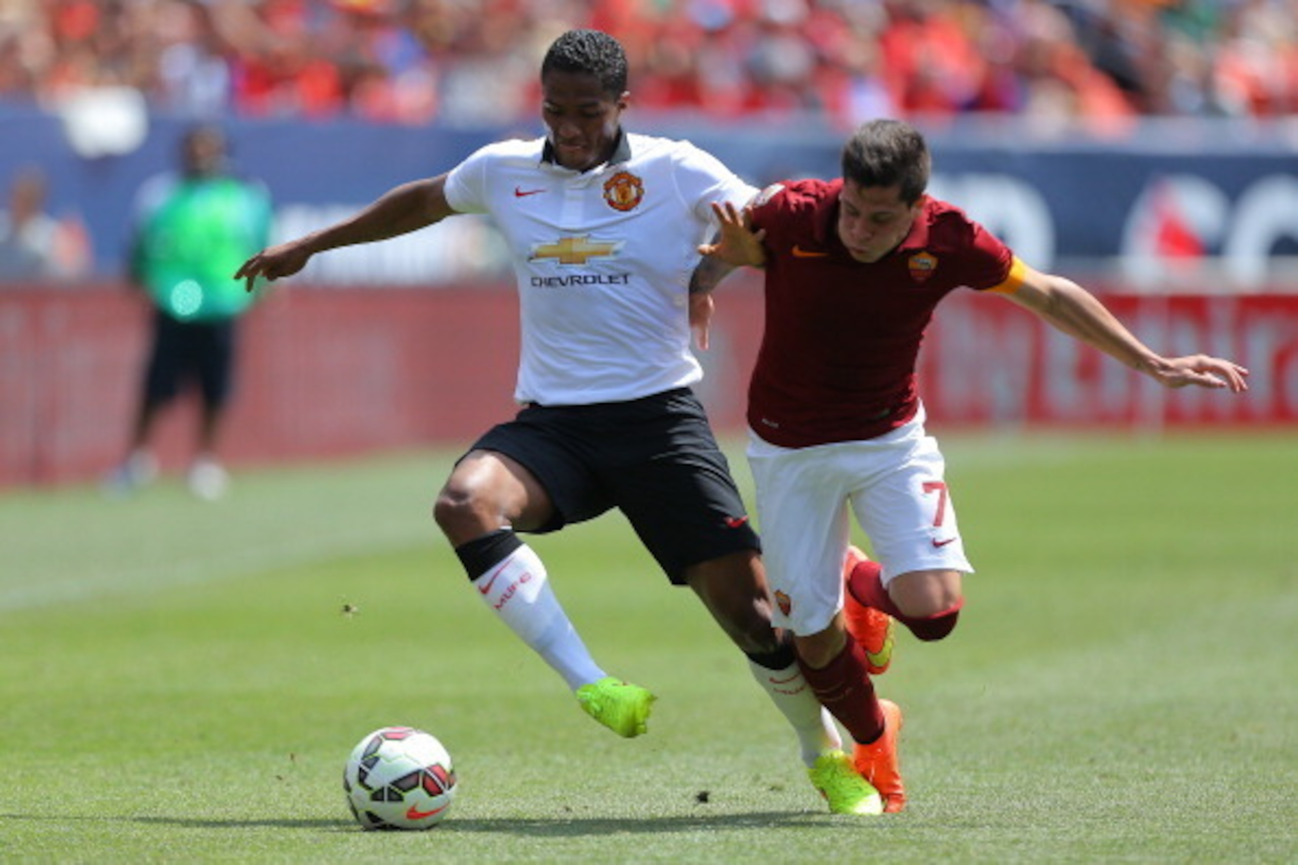DENVER, CO - JULY 26: Antonio Valencia #25 of Manchester United battles for the ball with Juan Iturbe #7 of AS Roma during the first half of an International Champions Cup match at Sports Authority Field at Mile High on July 26, 2014 in Denver, Colorado. 
