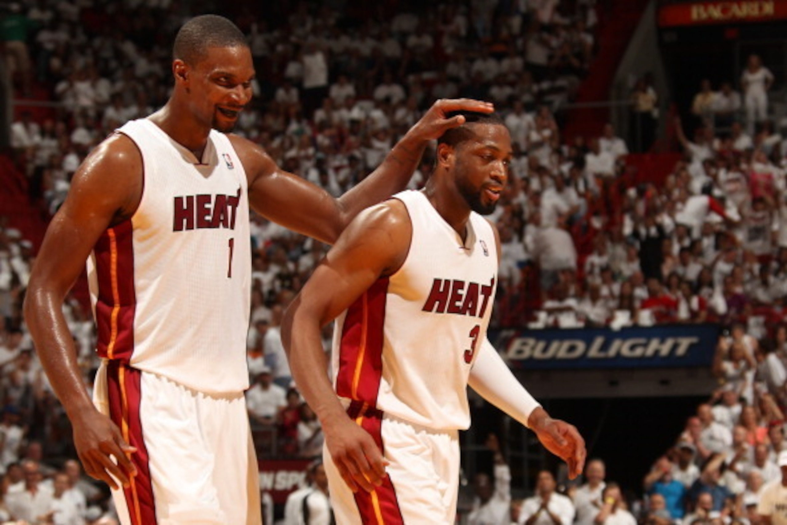 MIAMI, FL - April 20:  Chris Bosh #1 and Dwyane Wade #3 of the Miami Heat celebrate against the Charlotte Bobcats during Game One of the Eastern Conference Quarterfinals of the 2014 NBA playoffs at the American Airlines Arena in Miami, Florida on April 20