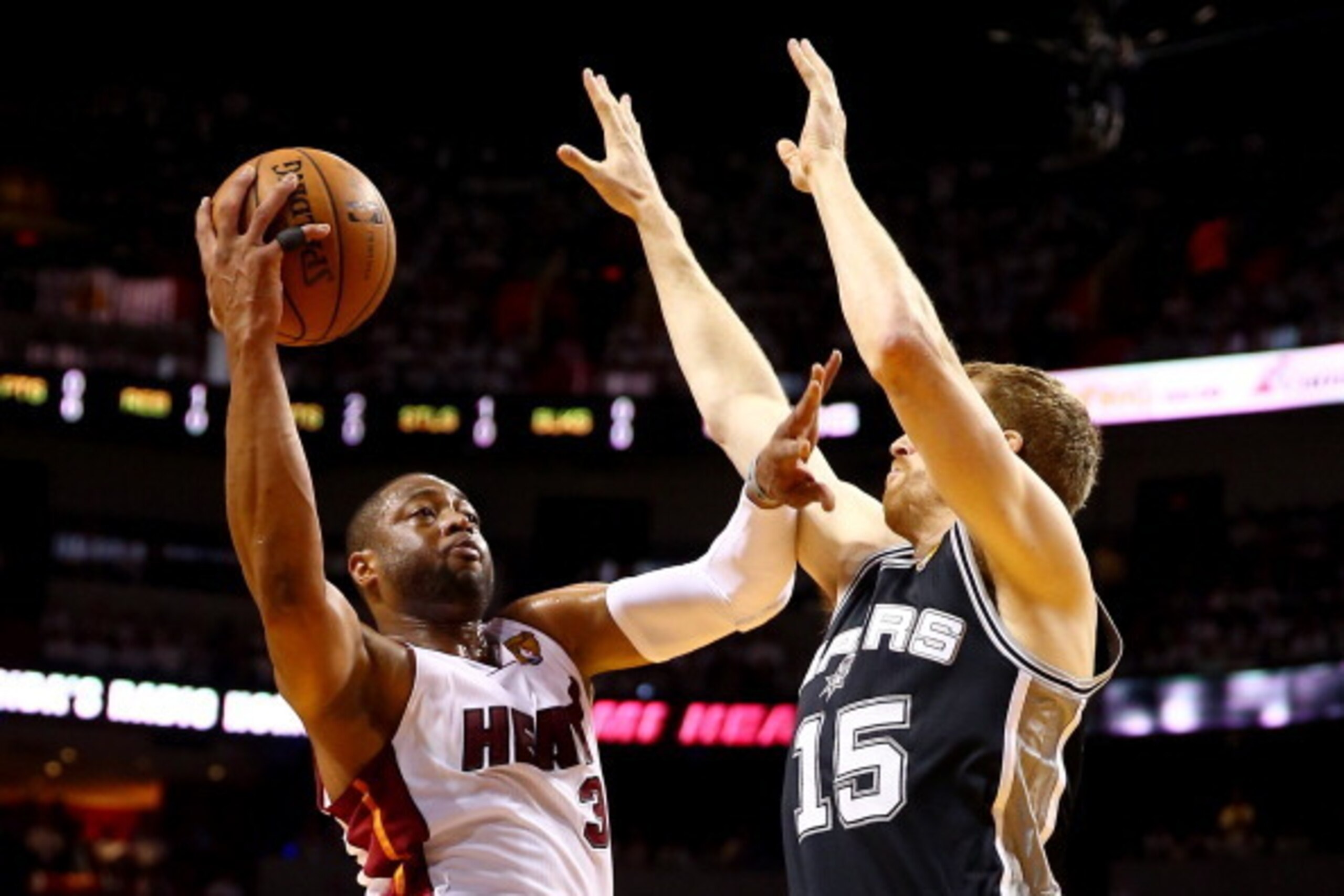 MIAMI, FL - JUNE 12:  Dwyane Wade #3 of the Miami Heat goes up to the basket against Matt Bonner #15 of the San Antonio Spurs during Game Four of the 2014 NBA Finals at American Airlines Arena on June 12, 2014 in Miami, Florida. NOTE TO USER: User express