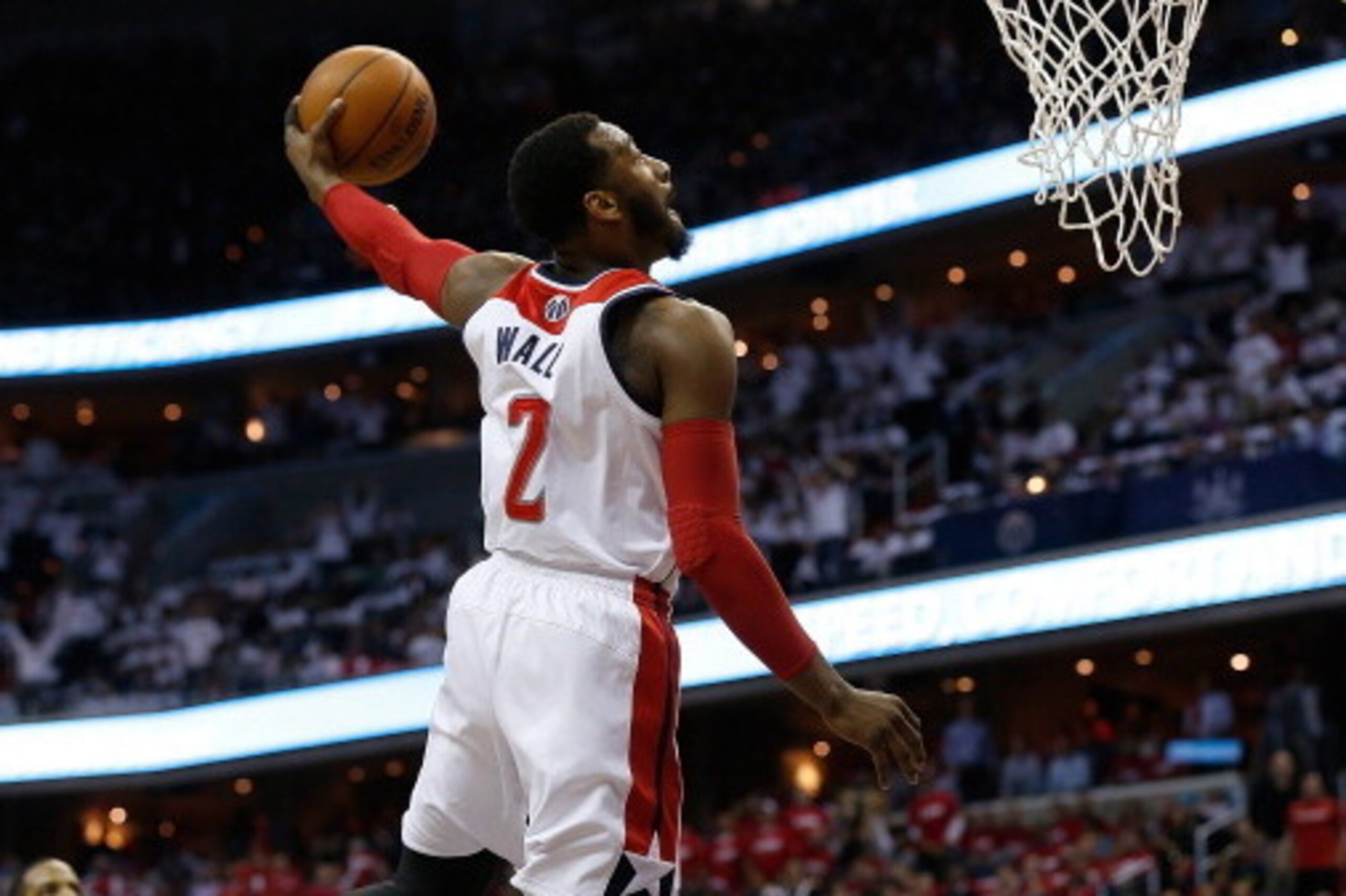 WASHINGTON, DC - APRIL 25:  John Wall #4 of the Washington Wizards drives to the basket for a dunk in first quarter action of Game 3 of the Eastern Conference Quarterfinals against the Chicago Bulls during the 2014 NBA Playoffs at the Verizon Center on Ap