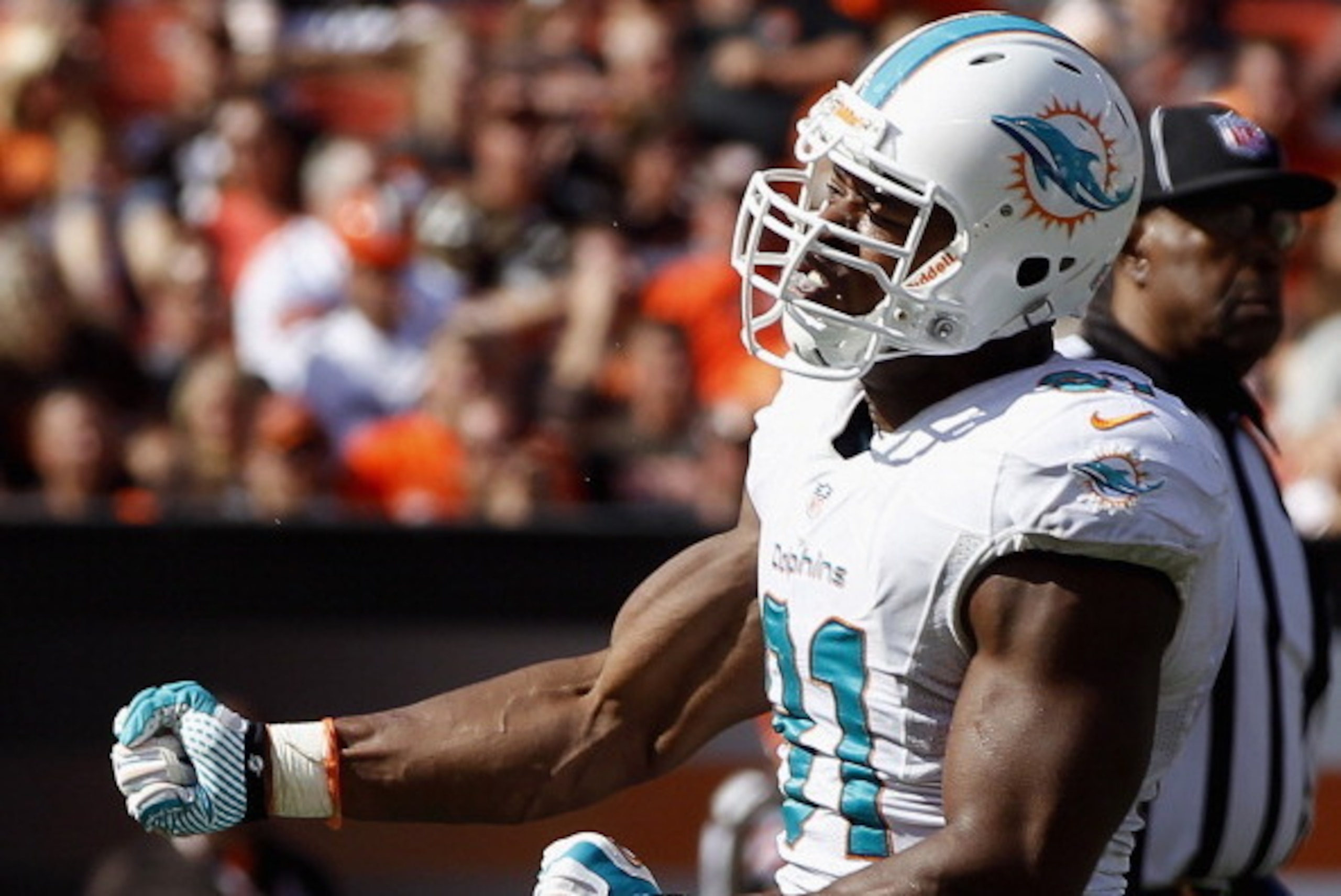 CLEVELAND, OH - SEPTEMBER 08: Defensive end Cameron Wake #91 of the Miami Dolphins celebrates after sacking quarterback Brandon Weeden #3 of the Cleveland Browns at Cleveland Browns Stadium on September 8, 2013 in Cleveland, Ohio. (Photo by Matt Sullivan/