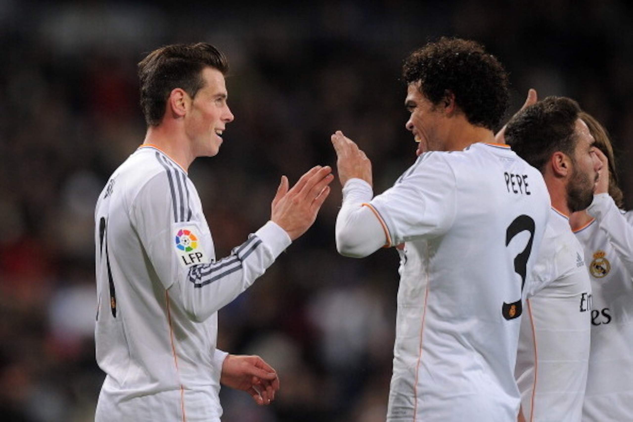 MADRID, SPAIN - NOVEMBER 30:  Gareth Bale (L) of Real Madrid CF celebrates with Pepe after scoring Real's 4th goal and his hat-trick during the La Liga match between Real Madrid CF and Real Valladolid CF at Santiago Bernabeu stadium on November 30, 2013 i