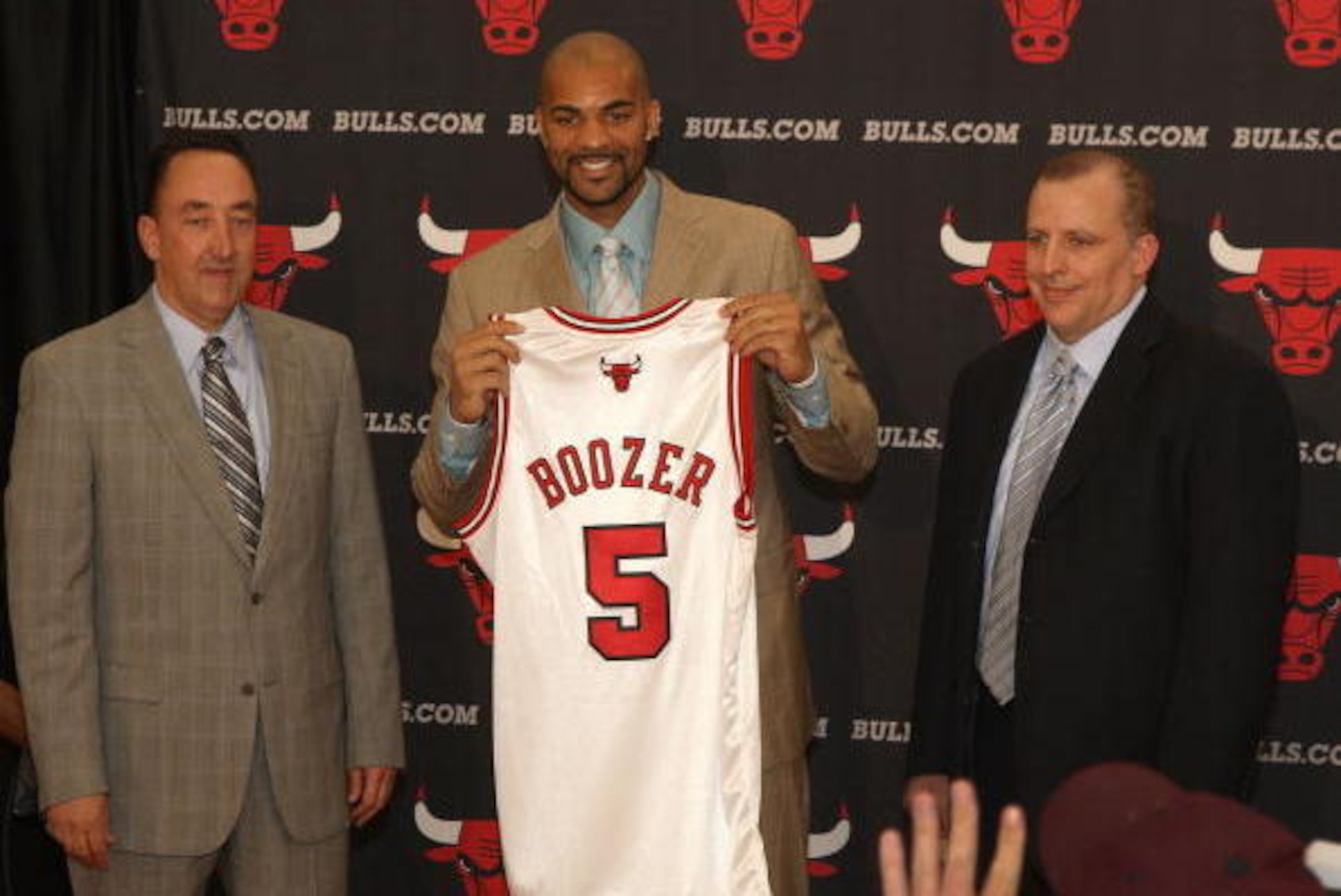 DEERFIELD , IL - JULY 09:  (L-R) General Manager Gar Forman, Carlos Boozer #5, and Head Coach Tom Thibodeau of the Chicago Bulls pose for a photograph following Boozer's signing as a free agent on July 9, 2010 at the Berto Center in Deerfield, Illinois.  