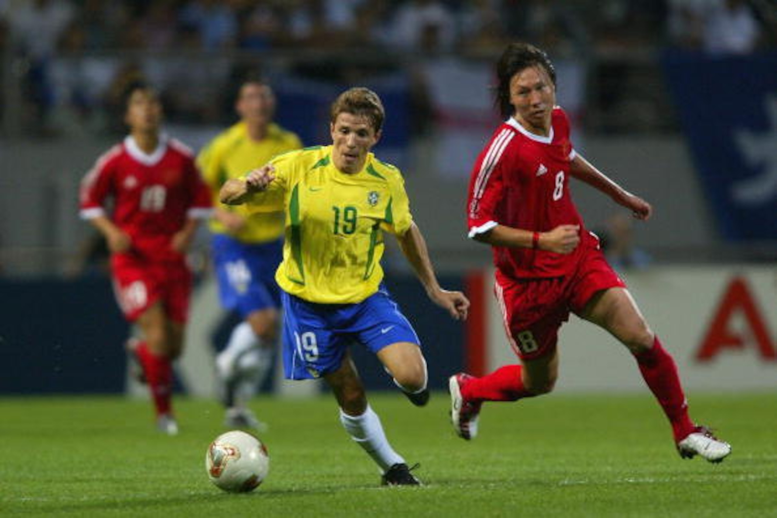 SEOGWIPO - JUNE 8:  Juninho Paulista of Brazil takes the ball past Tie Li of China during the FIFA World Cup Finals 2002 Group C match played at the Seogwipo-Jeju World Cup Stadium, in Seogwipo, South Korea on June 8, 2002. Brazil won the match 4-0. DIGIT