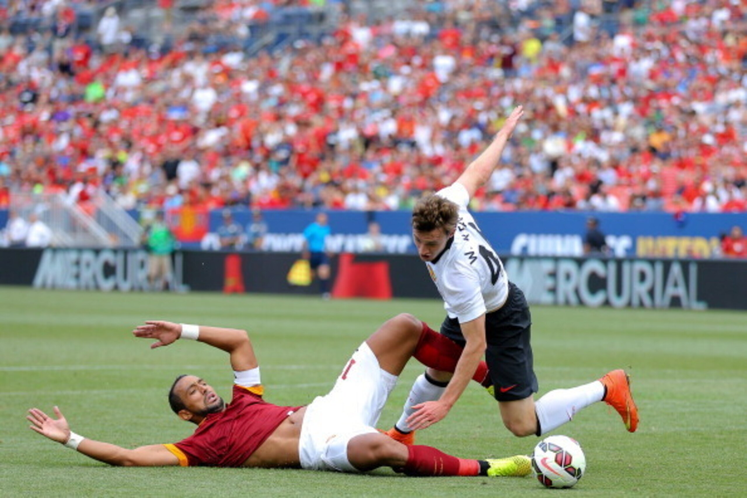 DENVER, CO - JULY 26: William Keane #48 of Manchester United and Mehdi Benatia #17 of AS Roma get tangled up during the second half of an International Champions Cup match at Sports Authority Field at Mile High on July 26, 2014 in Denver, Colorado. Manche