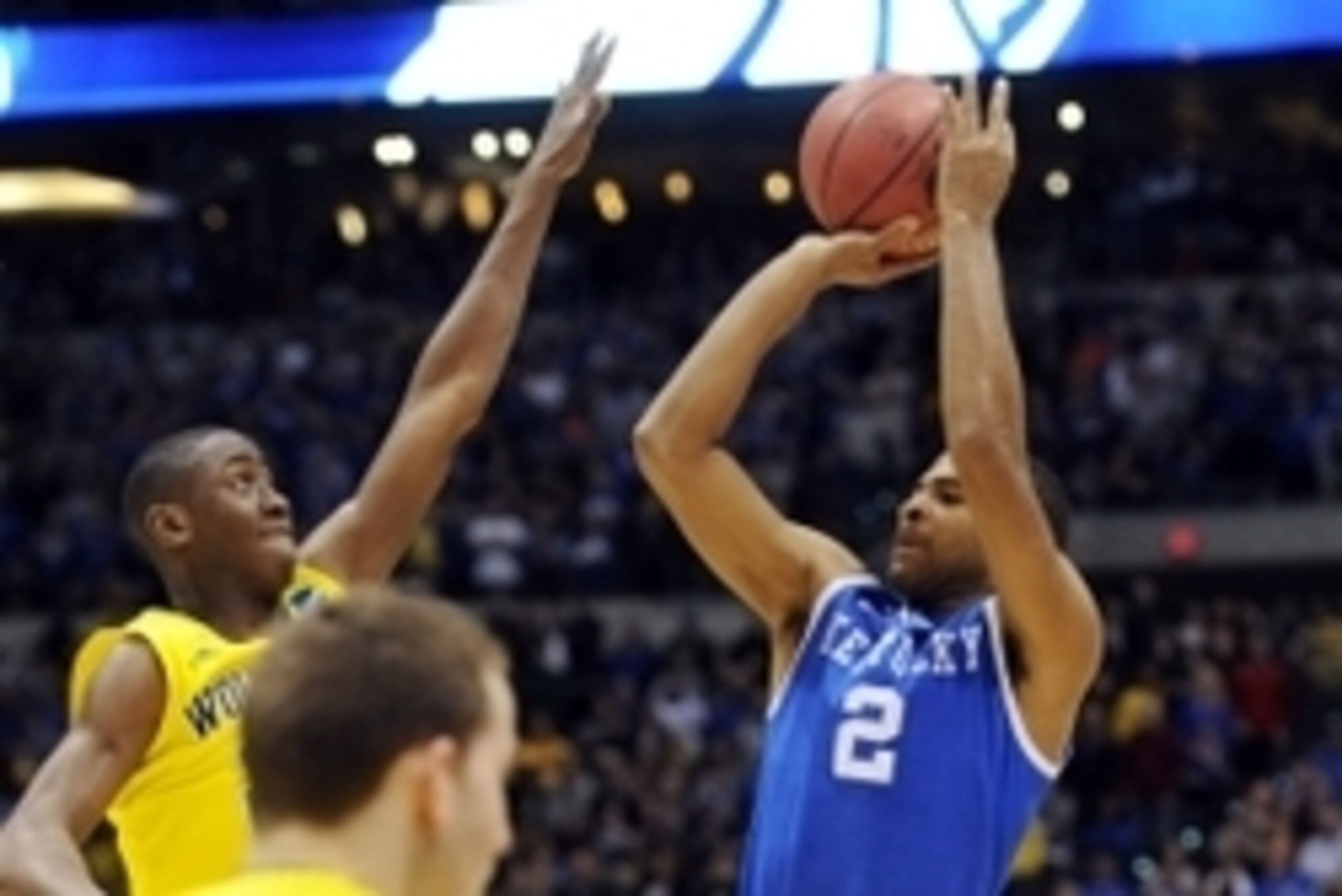 Mar 30, 2014; Indianapolis, IN, USA; Kentucky Wildcats guard Aaron Harrison (2) shoots and makes the game-winning three point shot over Michigan Wolverines guard Caris LeVert (left) in the second half in the finals of the midwest regional of the 2014 NCAA