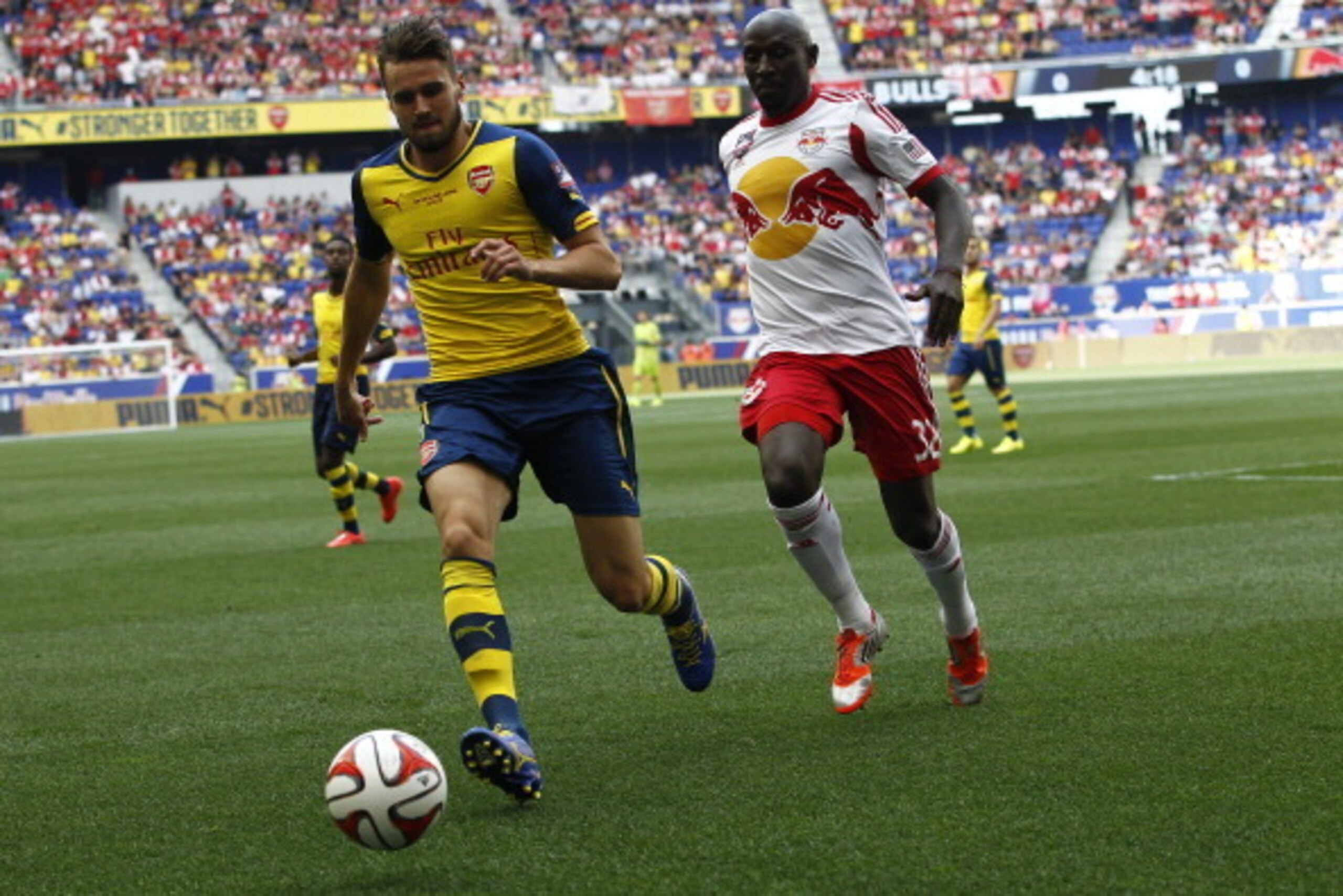 HARRISON, NJ - JULY 26:  Carl Jenkinson #25 of Arsenal fights for the ball with Ibrahim Sekagya #32 of New York Red Bulls during their friendly match at Red Bull Arena on July 26, 2014 in Harrison, NJ. (Photo by Jeff Zelevansky/Getty Images)