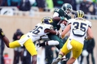 Nov 2, 2013; East Lansing, MI, USA; Michigan State Spartans wide receiver Tony Lippett (14) makes a catch against Michigan Wolverines defensive back Jourdan Lewis (26) during the 1st half of a game at Spartan Stadium. Mandatory Credit: Mike Carter-USA TOD