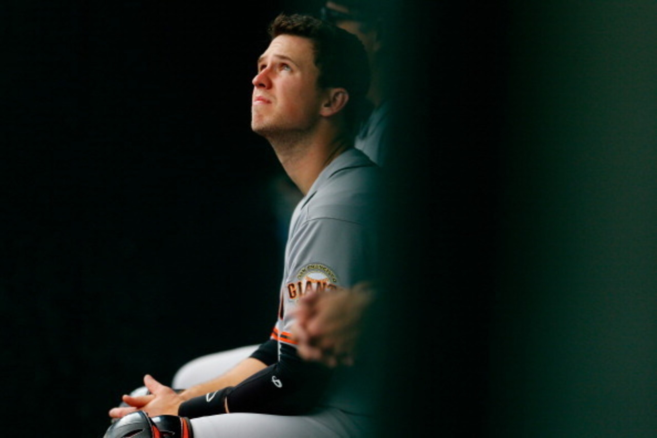 NEW YORK, NY - AUGUST 04:  Buster Posey #28 of the San Francisco Giants looks on from the bench during the game against the New York Mets at Citi Field on August 4, 2014 in the Flushing neighborhood of the Queens borough of New York City.  (Photo by Mike 