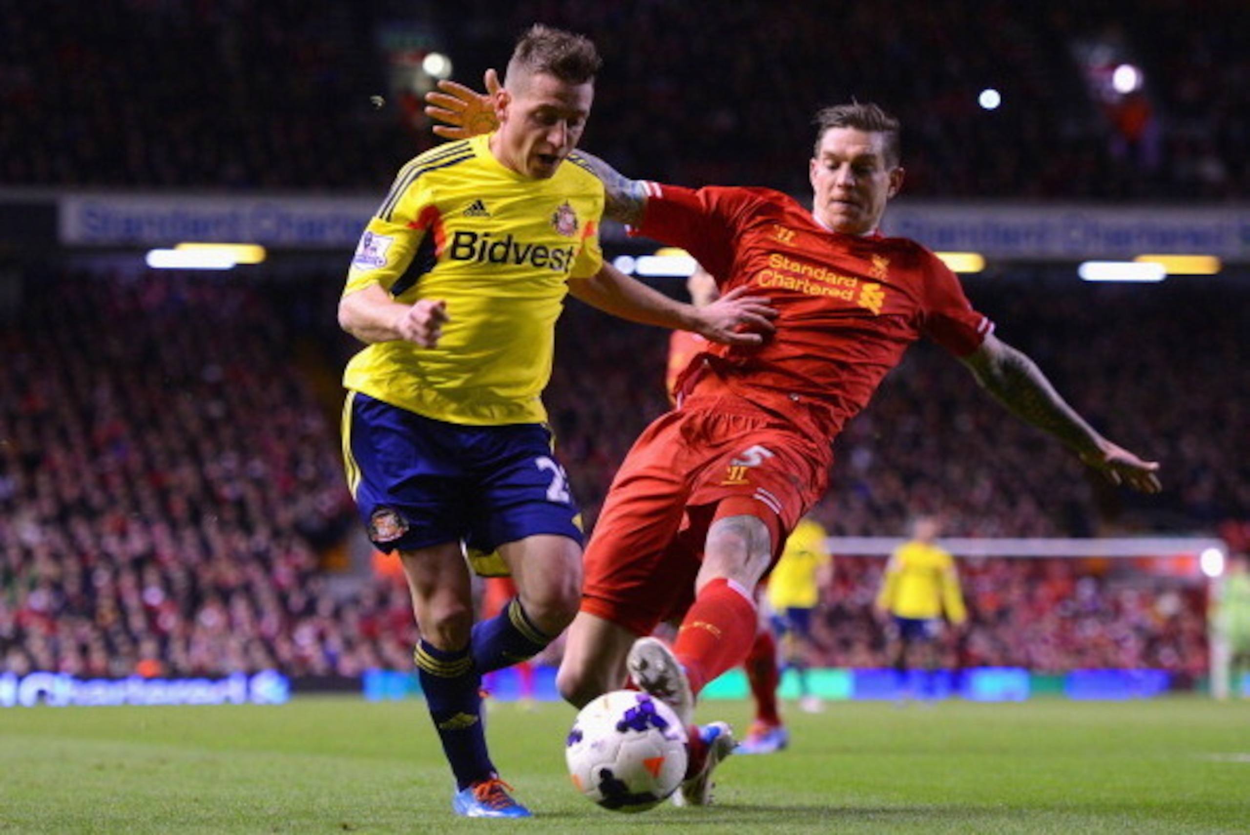 LIVERPOOL, ENGLAND - MARCH 26:  Daniel Agger of Liverpool challenges Emanuele Giaccherini of Sunderland during the Barclays Premier League match between Liverpool and Sunderland at Anfield on March 26, 2014 in Liverpool, England.  (Photo by Michael Regan/
