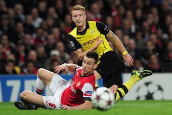 LONDON, ENGLAND - OCTOBER 22: Marco Reus of Borussia Dortmund and Laurent Koscielny of Arsenal in action during the UEFA Champions League Group F match between Arsenal and  Borussia Dortmund at Emirates Stadium on October 22, 2013 in London, England.  (Ph