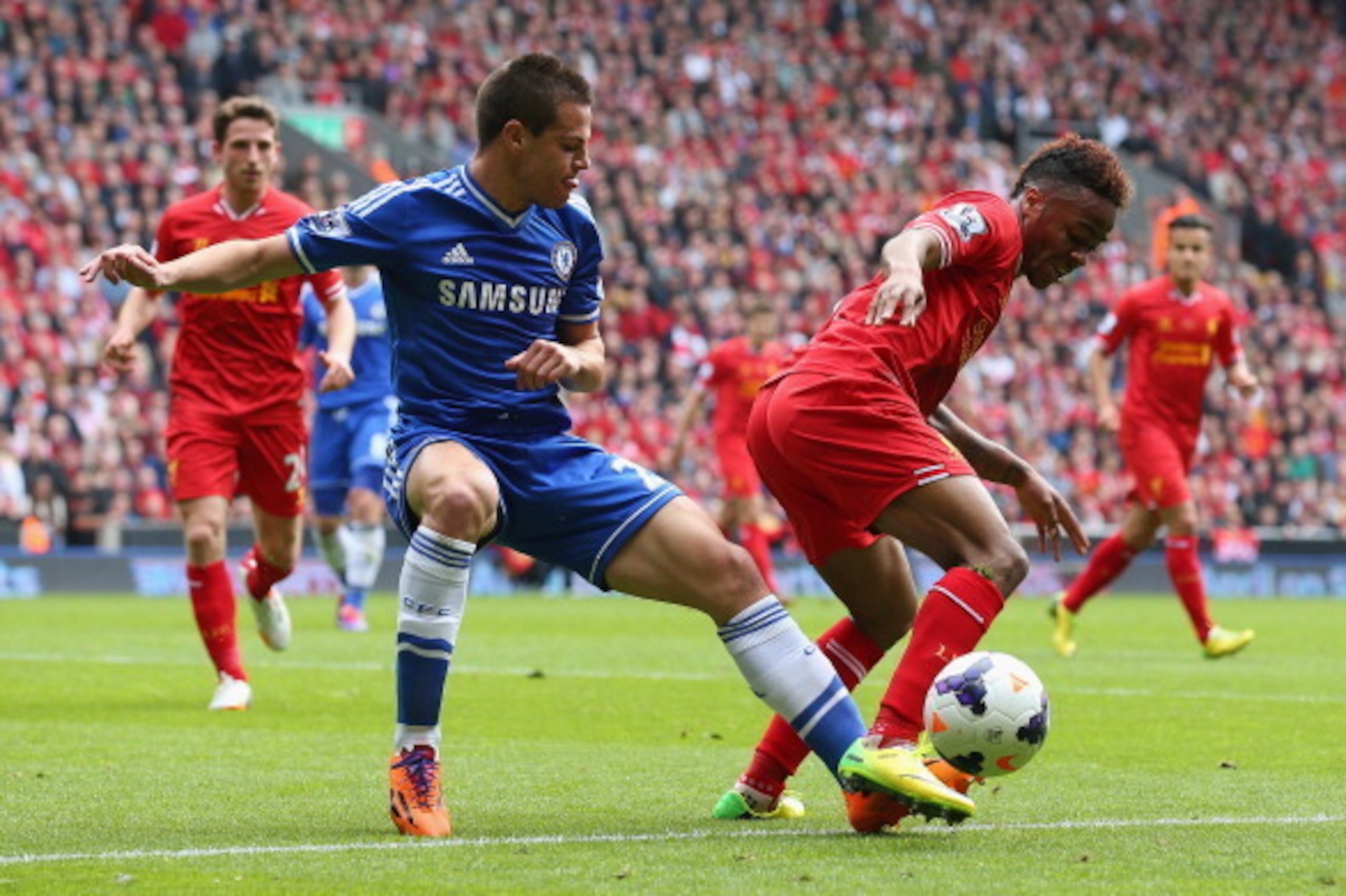 LIVERPOOL, ENGLAND - APRIL 27: Cesar Azpilicueta of Chelsea marshalls Raheem Sterling of Liverpool during the Barclays Premier League match between Liverpool and Chelsea at Anfield on April 27, 2014 in Liverpool, England.  (Photo by Clive Brunskill/Getty 