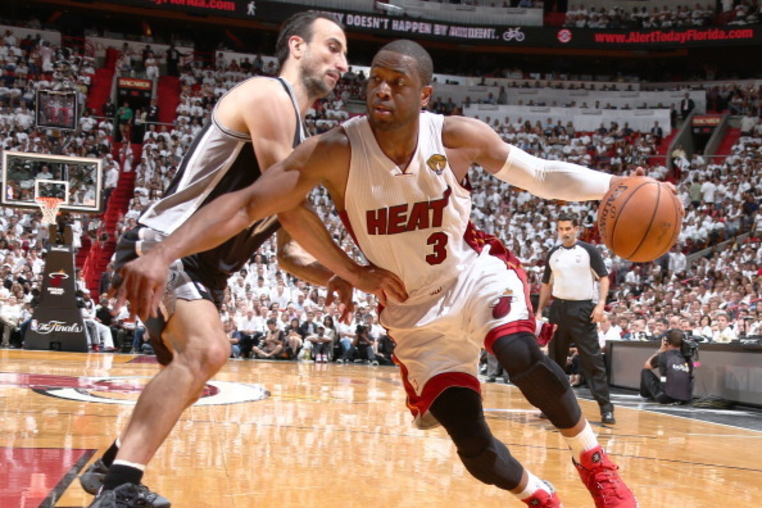 MIAMI, FL - JUNE 10: Dwyane Wade #3 of the Miami Heat drives against Manu Ginobili #20 of the San Antonio Spurs during Game Three of the 2014 NBA Finals at American Airlines Arena in Miami, Florida on June 10, 2014.  NOTE TO USER: User expressly acknowled