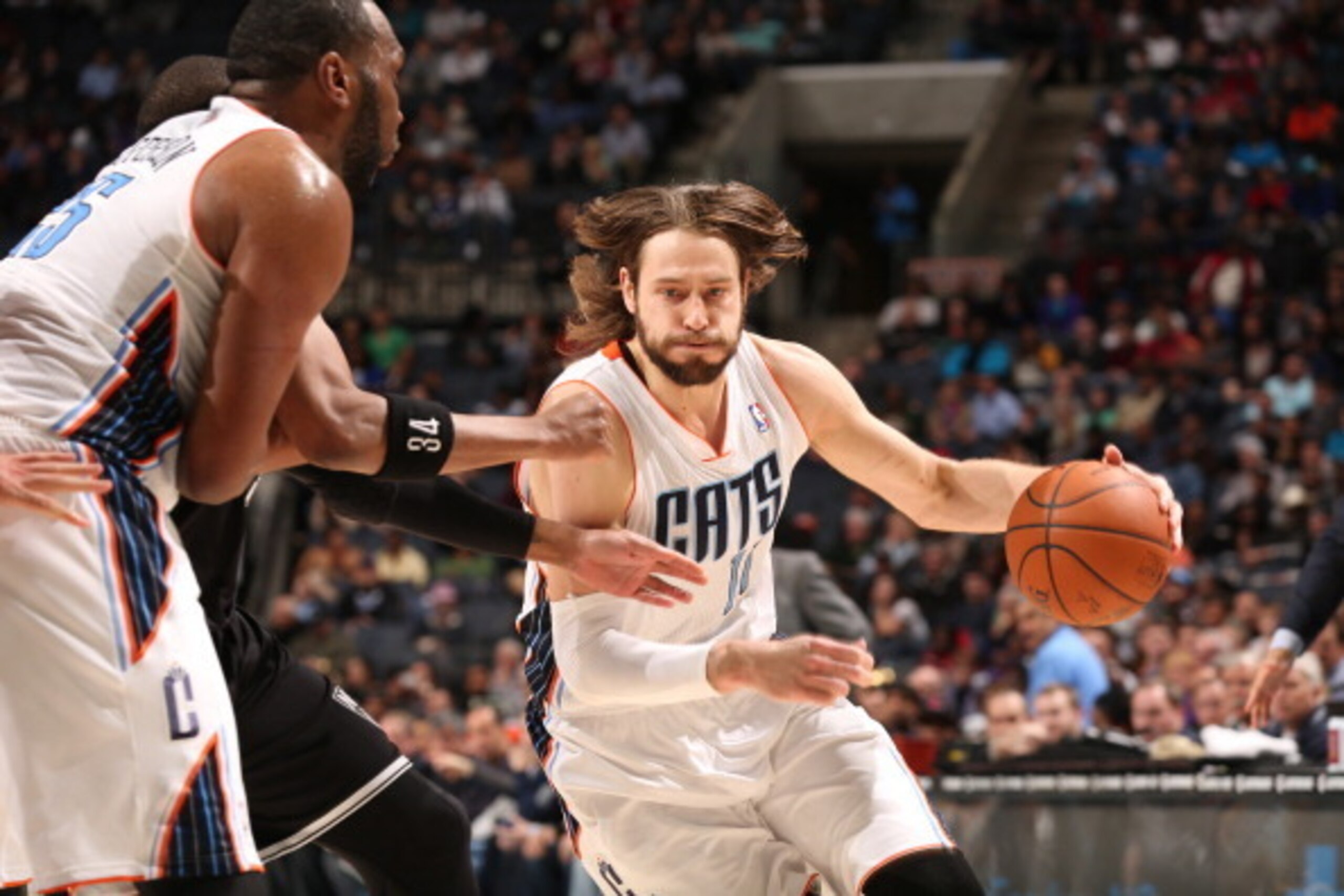 CHARLOTTE, NC - MARCH 26:  Josh McRoberts #11 of the Charlotte Bobcats handles the ball against the Brooklyn Nets at the Time Warner Cable Arena on March 26, 2014 in Charlotte, North Carolina. NOTE TO USER: User expressly acknowledges and agrees that, by 