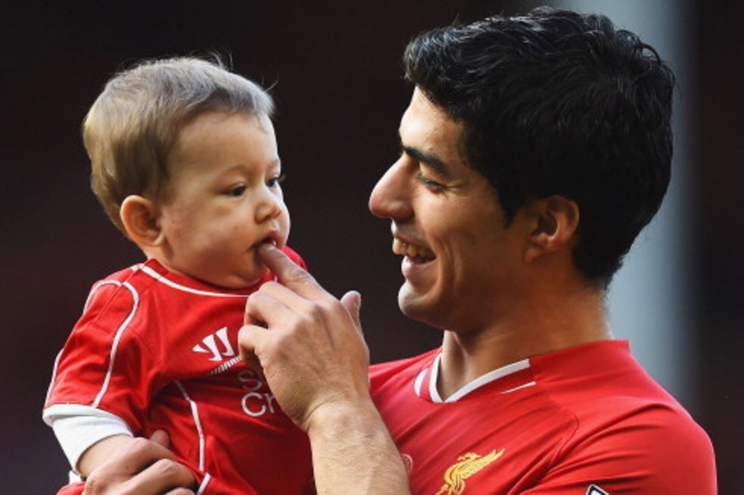 LIVERPOOL, ENGLAND - MAY 11:  Luis Suarez of Liverpool with his son Benjamin after the Barclays Premier League match between Liverpool and Newcastle United at Anfield on May 11, 2014 in Liverpool, England. Liverpool finish as runners-up in the Premier Lea