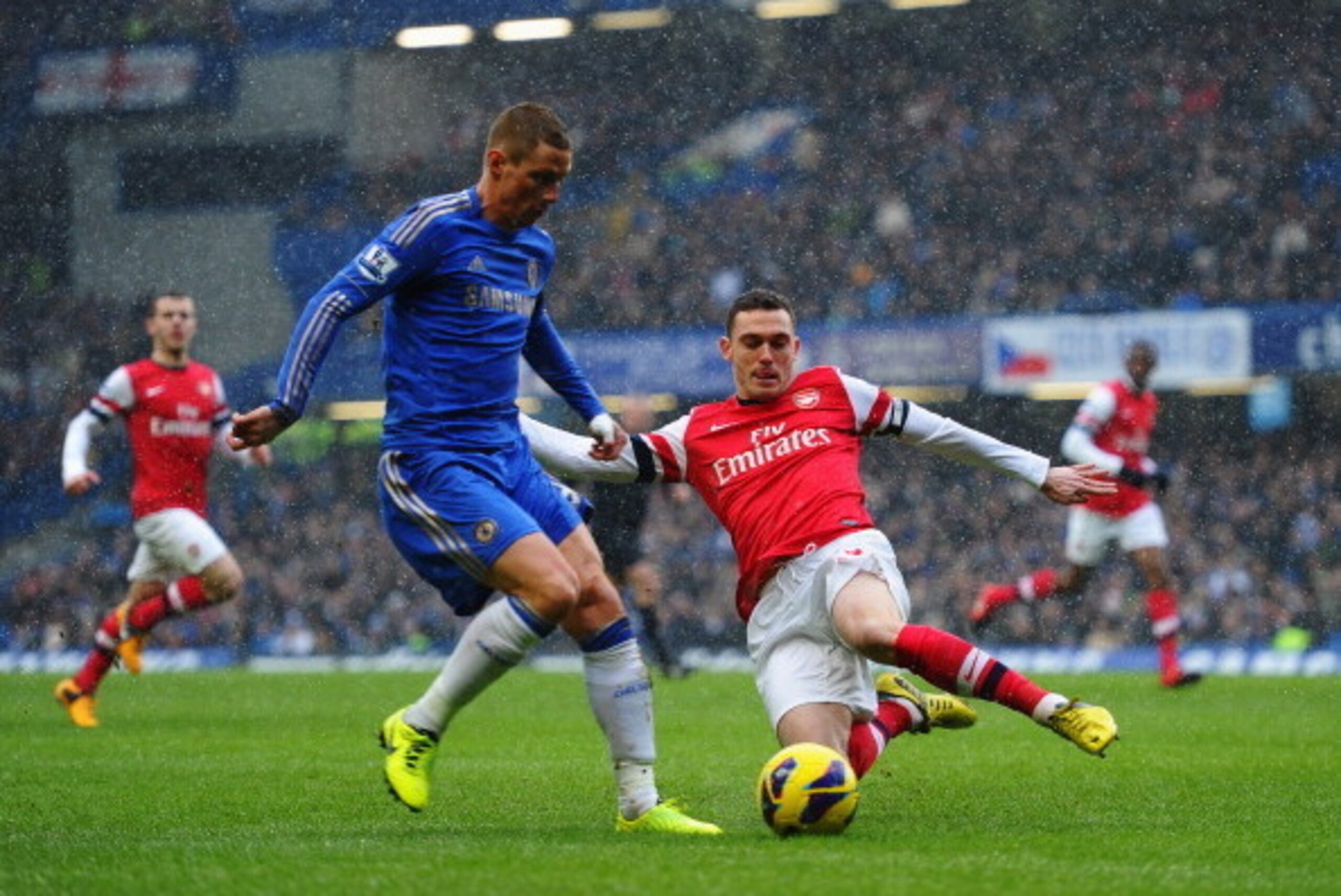 LONDON, ENGLAND - JANUARY 20:  Thomas Vermaelen of Arsenal tackles Fernando Torres of Chelsea during the Barclays Premier League match between Chelsea and Arsenal at Stamford Bridge on January 20, 2013 in London, England.  (Photo by Laurence Griffiths/Get